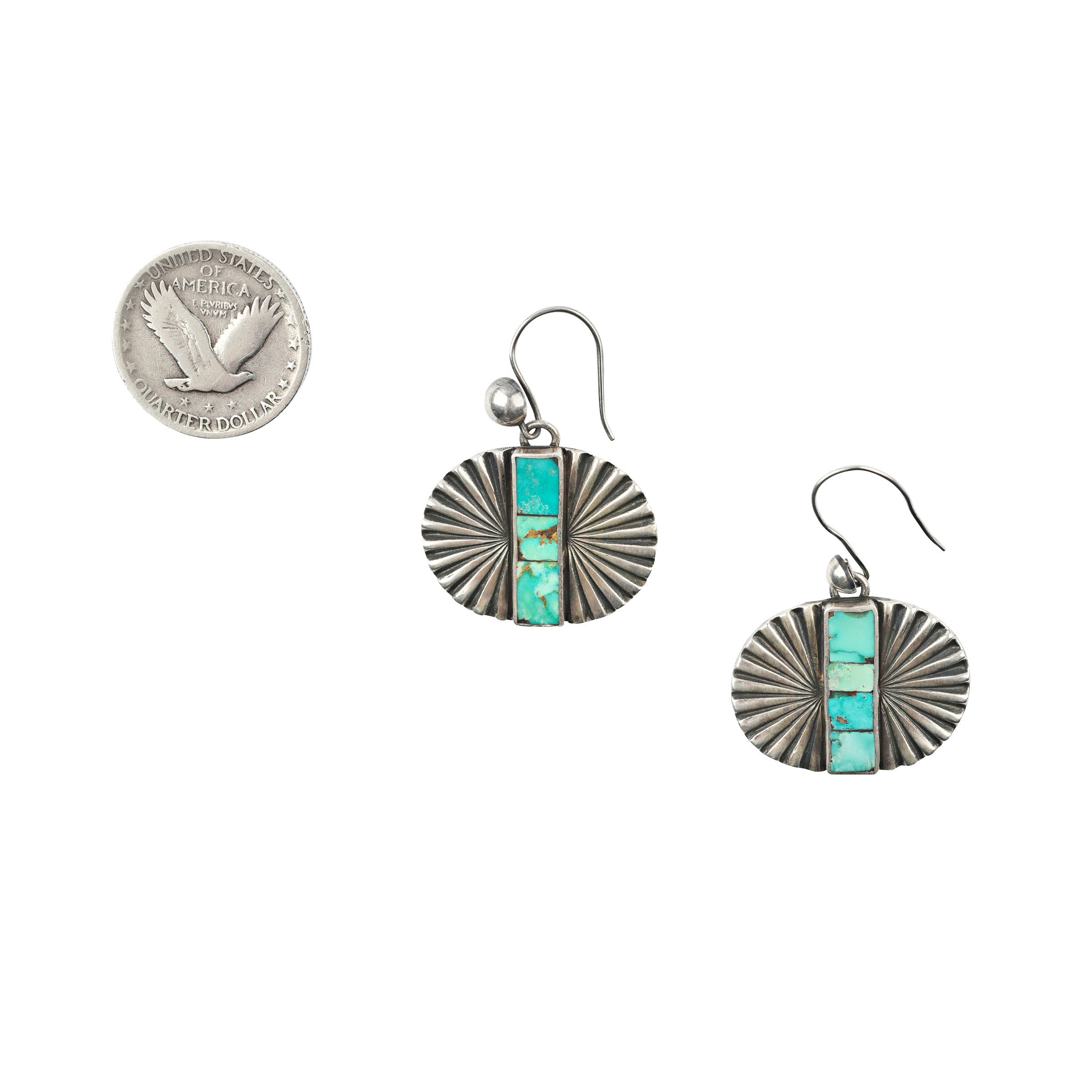 As seen in the Sundance Catalog, a pair of Sterling Silver cast earrings with Southwestern motifs featuring a strip of mosaic Turquoise in the middle