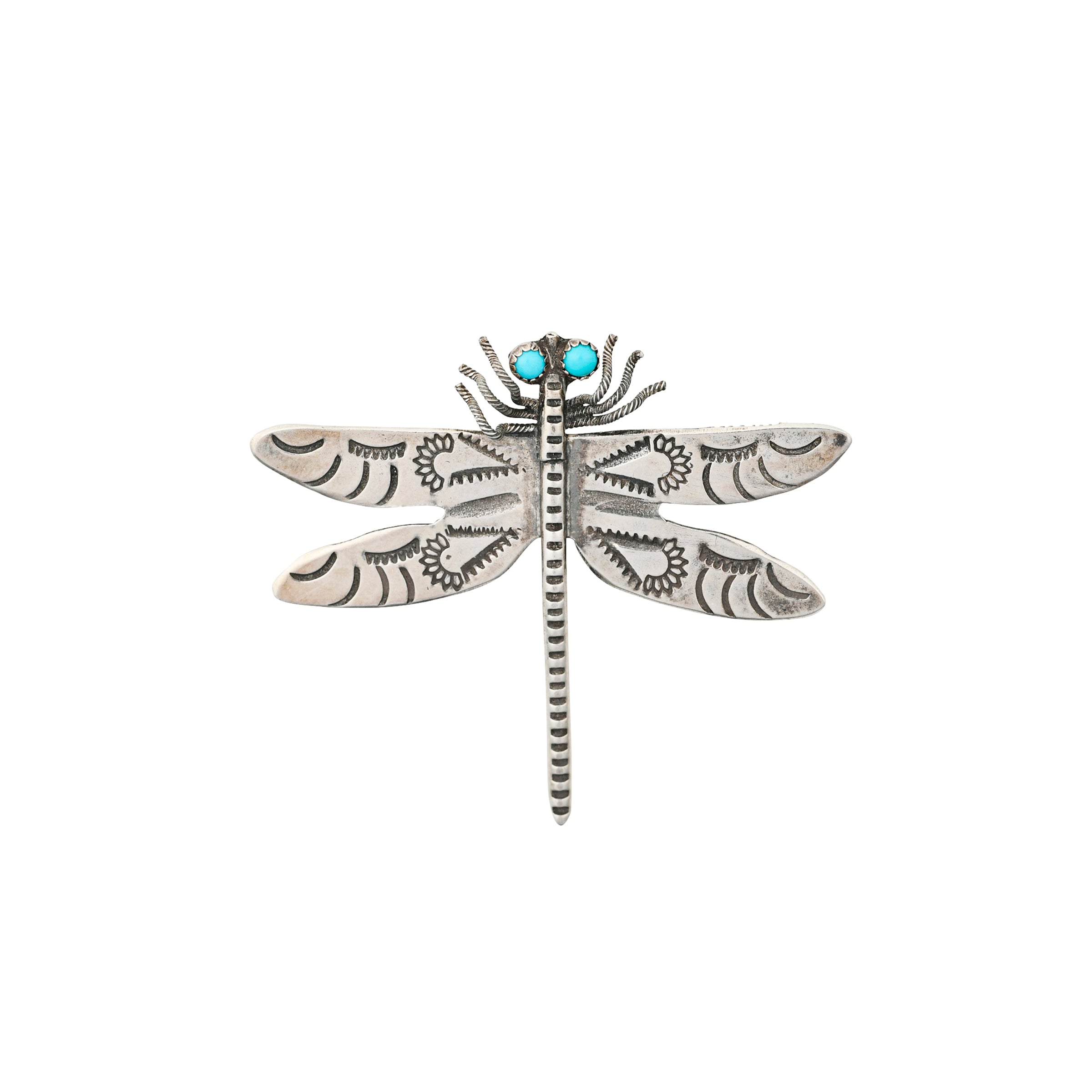 A Sterling Silver pin of a dragonfly with detailed stamping on the wings and Blue Turquoise for eyes.