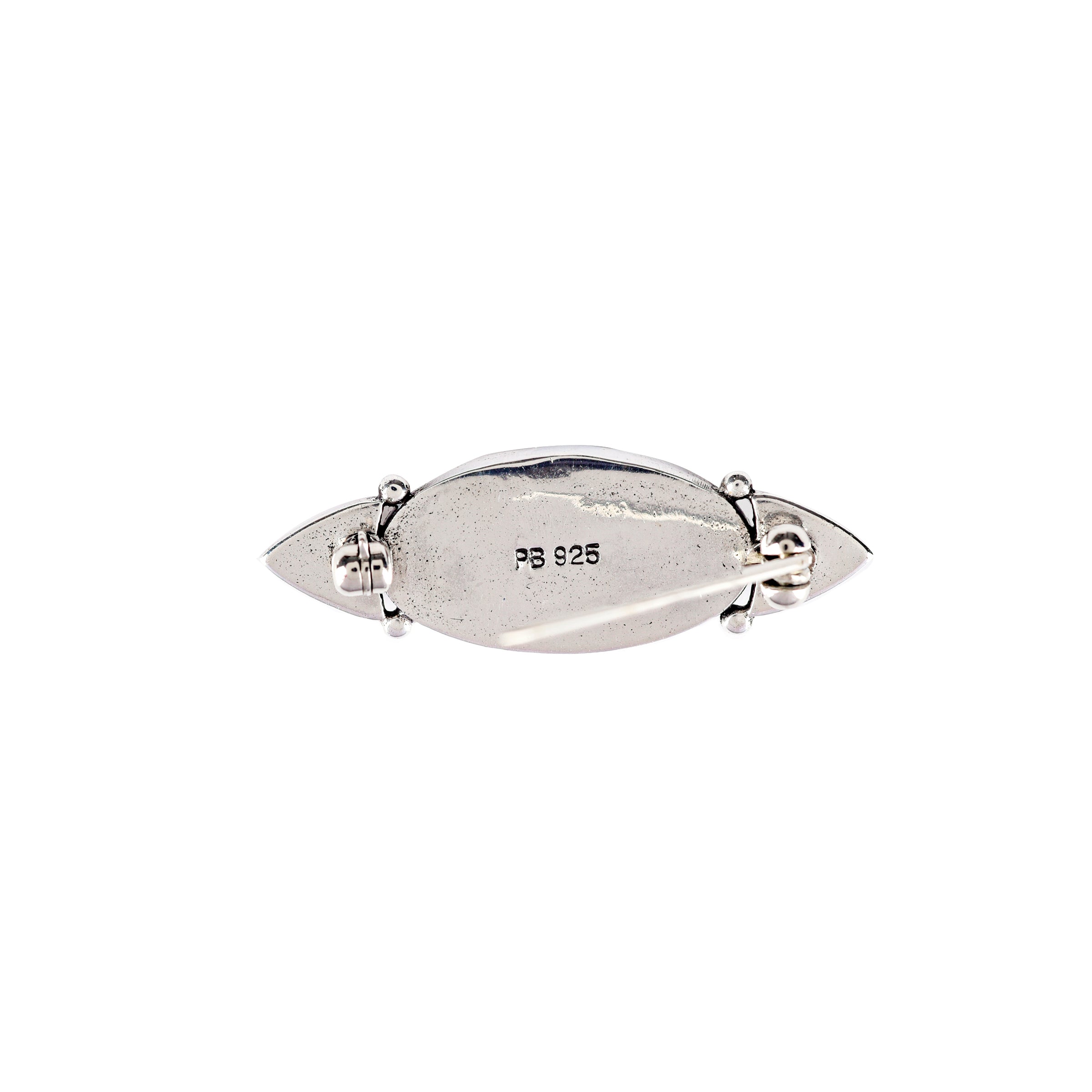 A sterling silver pin with a blue turquoise stone and intricate designs on each end.