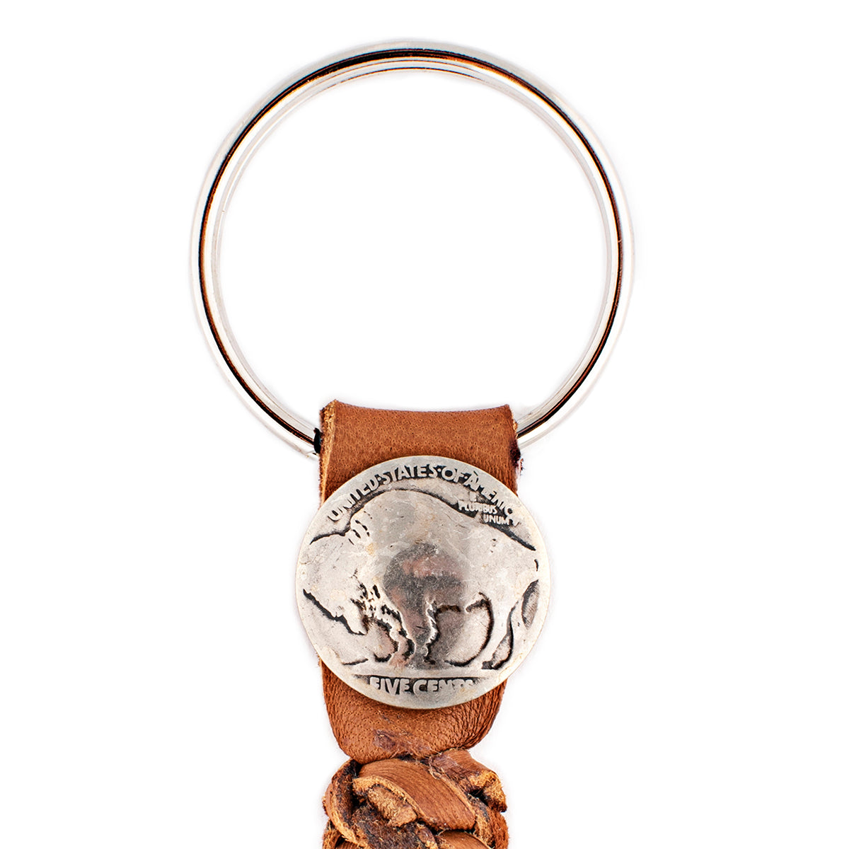 A tobacco leather tassel keychain with a silver metal key ring and a vintage buffalo nickel. 