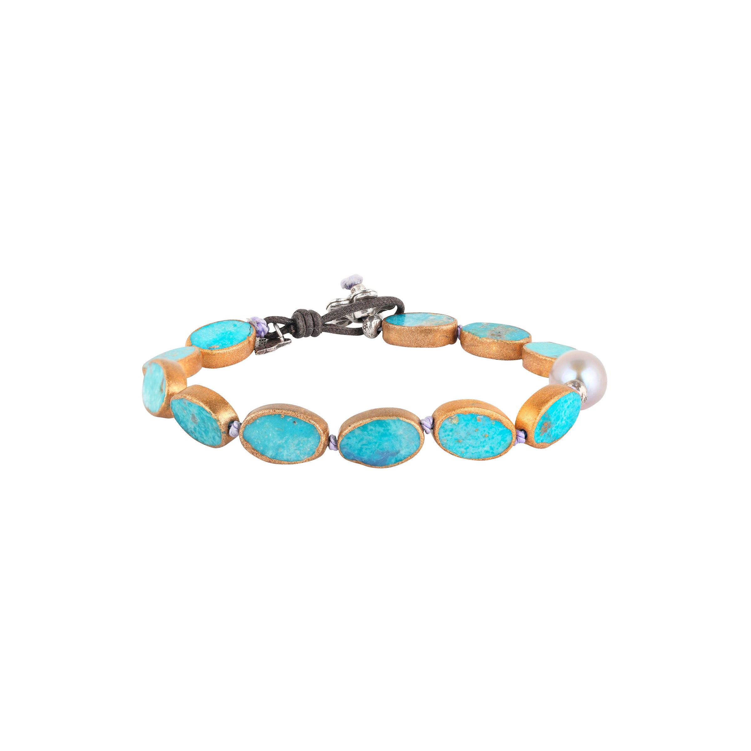 The Oasis Bracelet is a beaded heirloom strung with electroplated Turquoise and an off-center Freshwater Pearl finished with a charming floral toggle for a stylish fit.