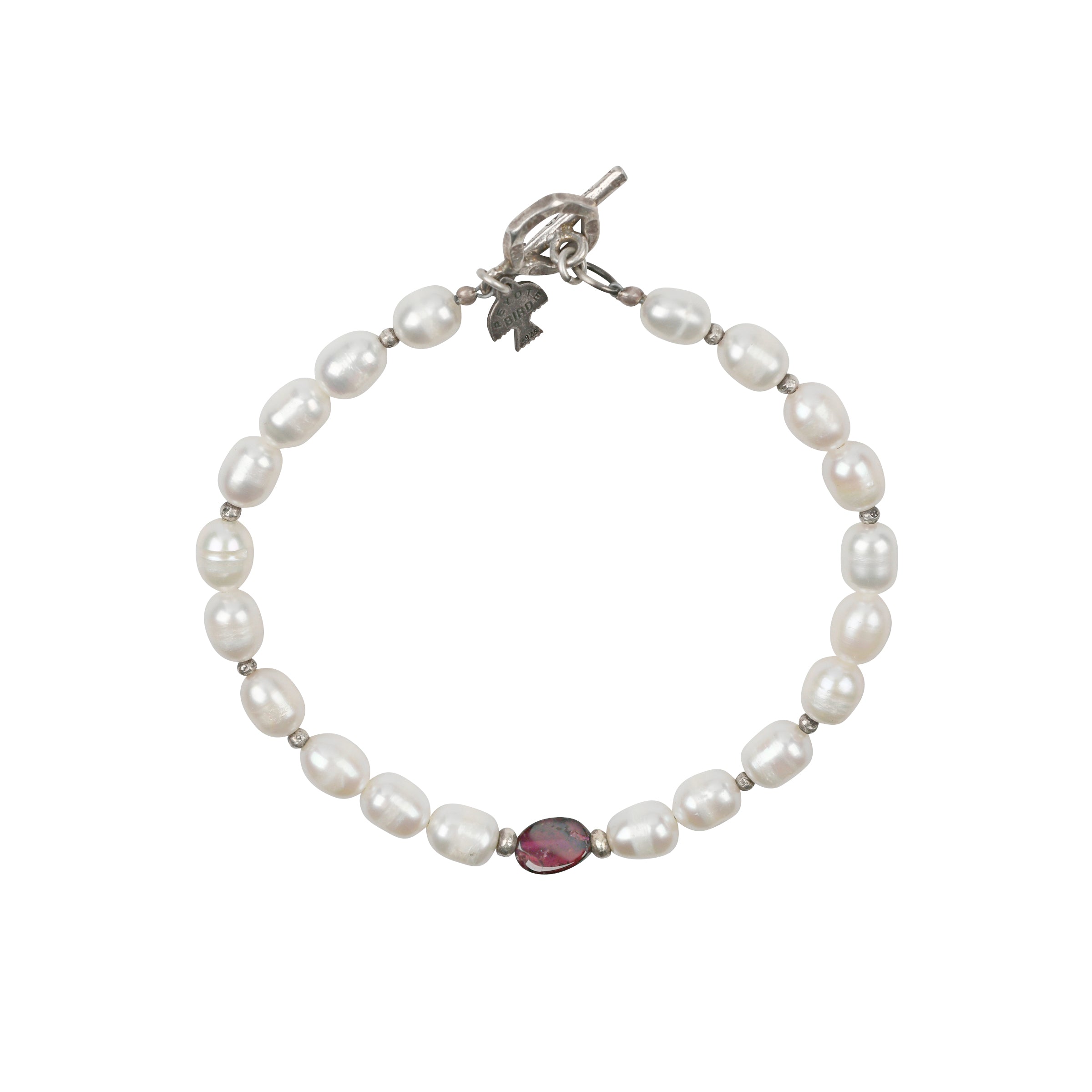 A Peyote Bird Original Bracelet strung with Sterling Silver, Freshwater Pearls, and a single Garnet as the centerpiece. As seen in the Sundance Catalog!
