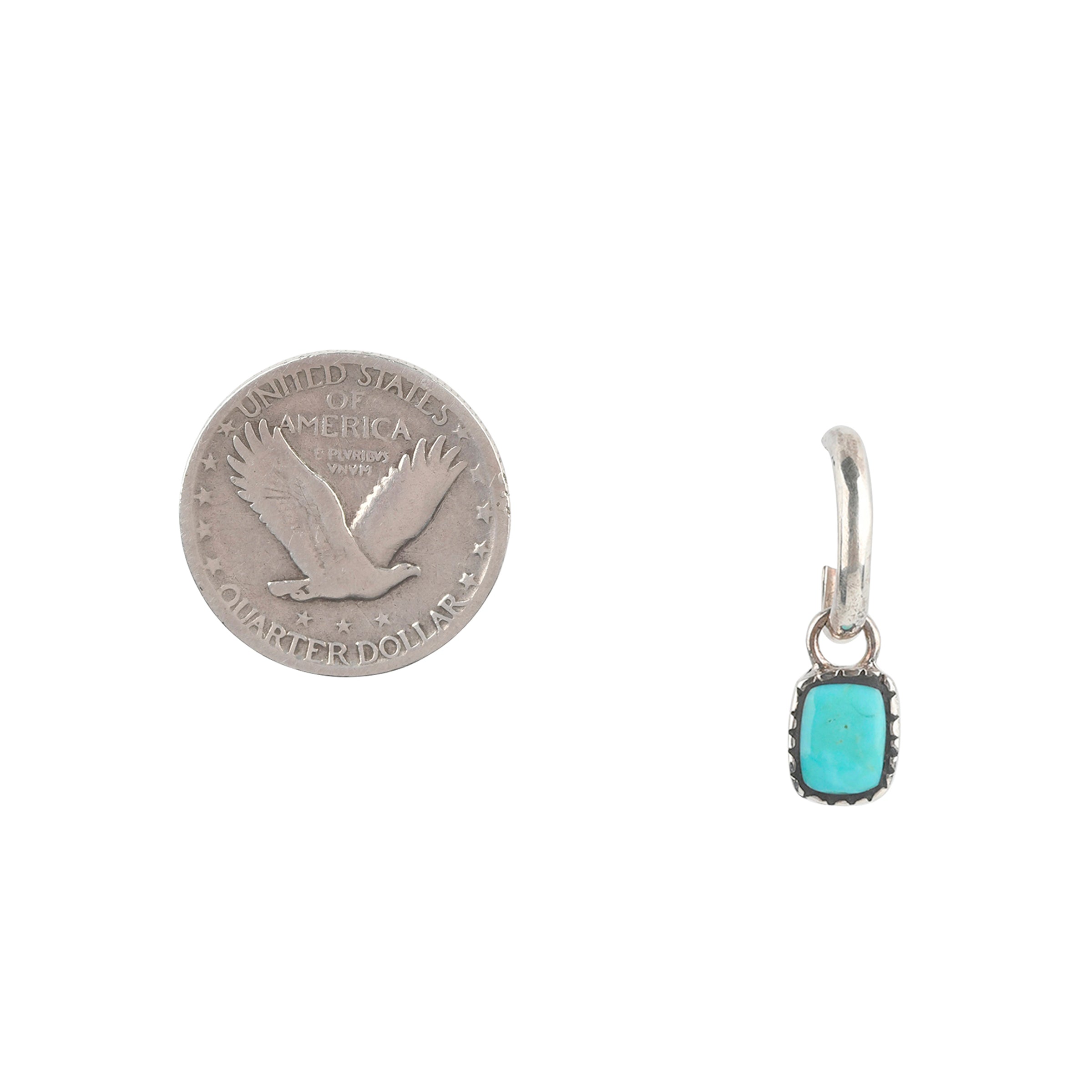 A Sterling Silver hoop earring featuring a charm of inlayed Blue Turquoise. 