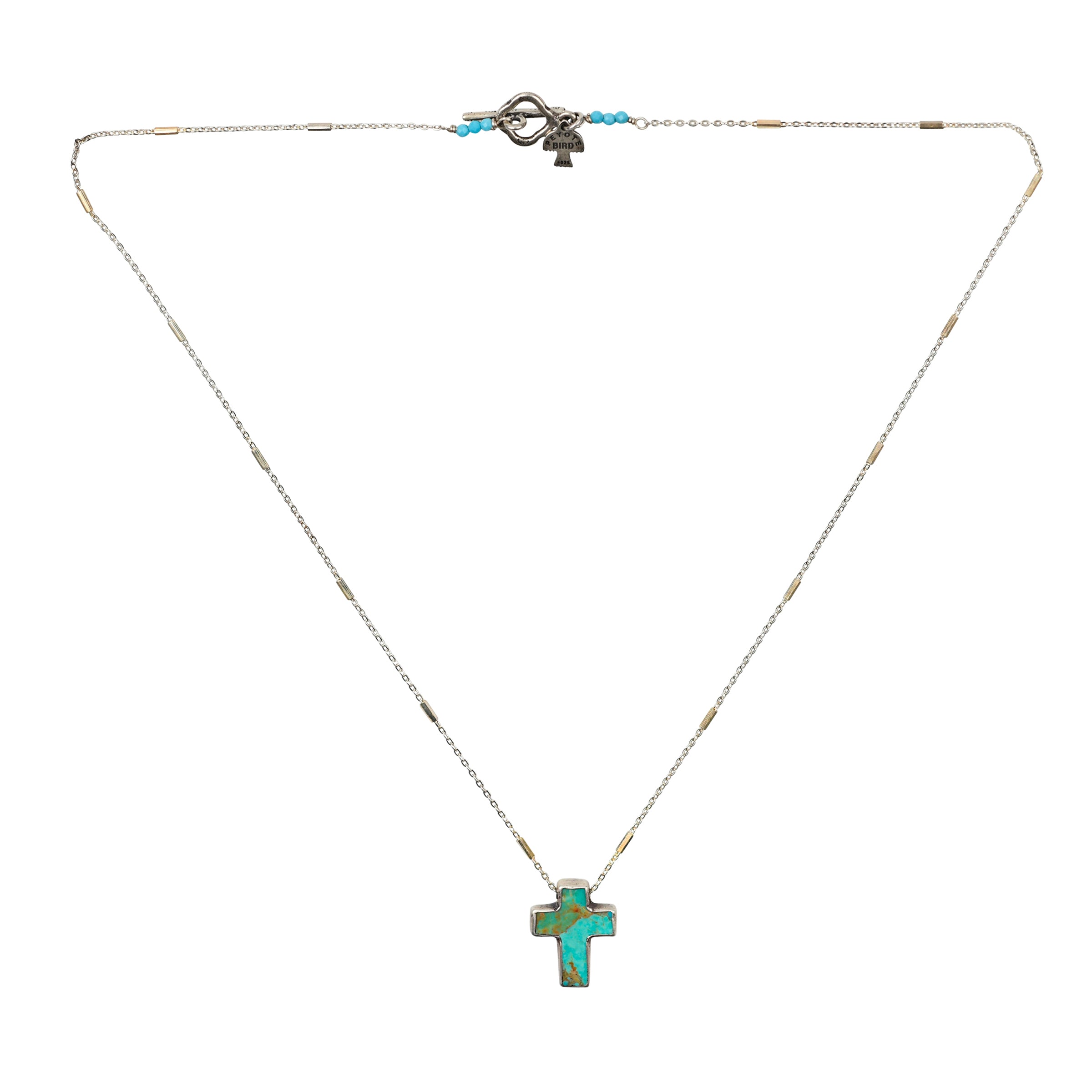 As seen in the Sundance Catalog, the Sanctuary Cross Necklace is a carved Turquoise cross set in Sterling Silver on a simple Sterling Silver chain.