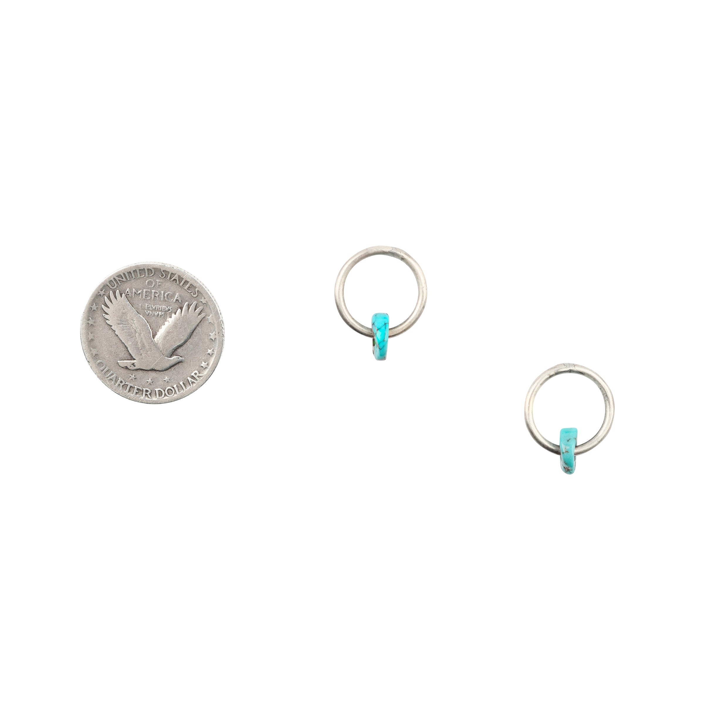 As seen in the Sundance Catalog, the In the Circle Earrings are stud earrings featuring Sterling Silver hoops with a single Blue Turquoise disc bead.