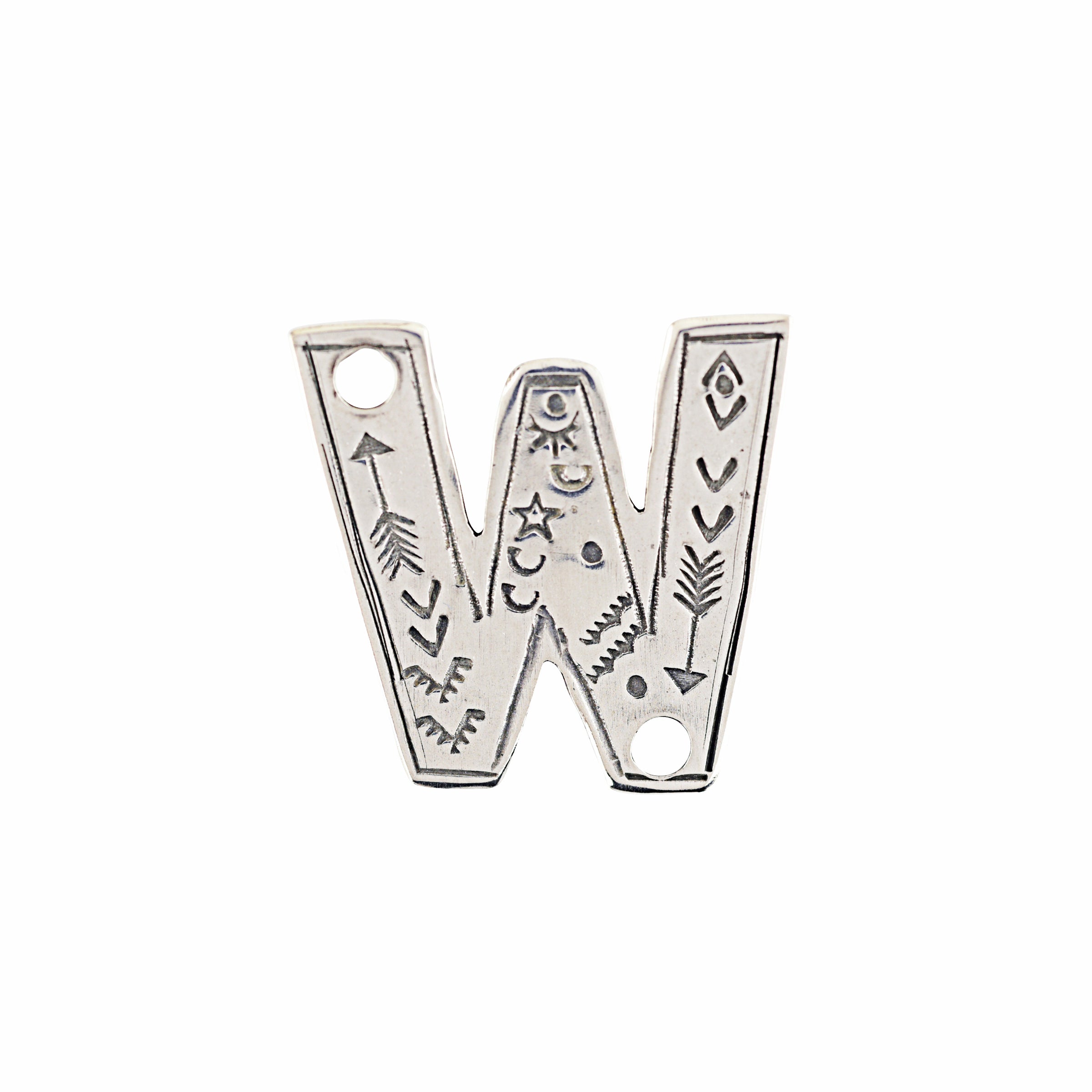 A sterling silver W Charm from artist Joe Eby that is a perfect addition to any hat or jacket.