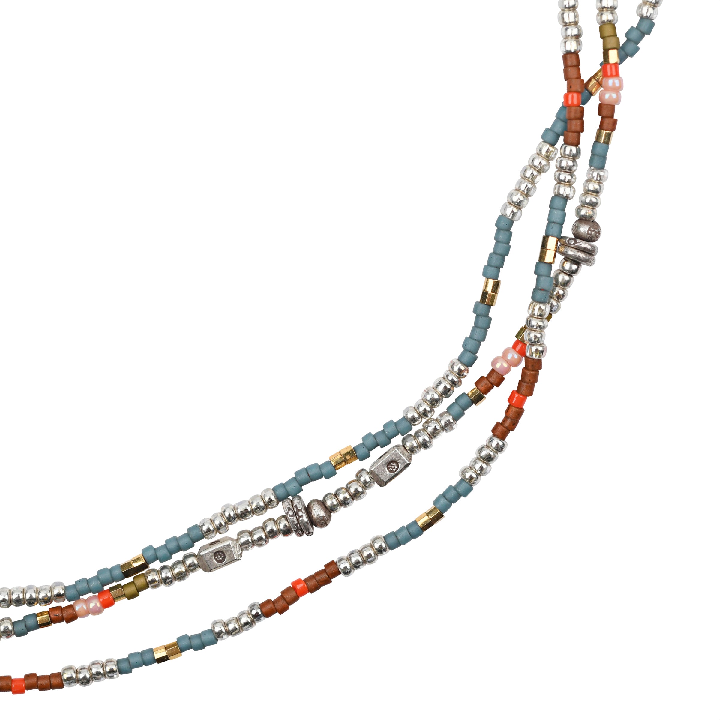 As seen in the Sundance Catalog. A multi-colored 3-strand necklace strung with glass seed beads and Thai sterling silver stamped beading. Finished with a hook toggle.