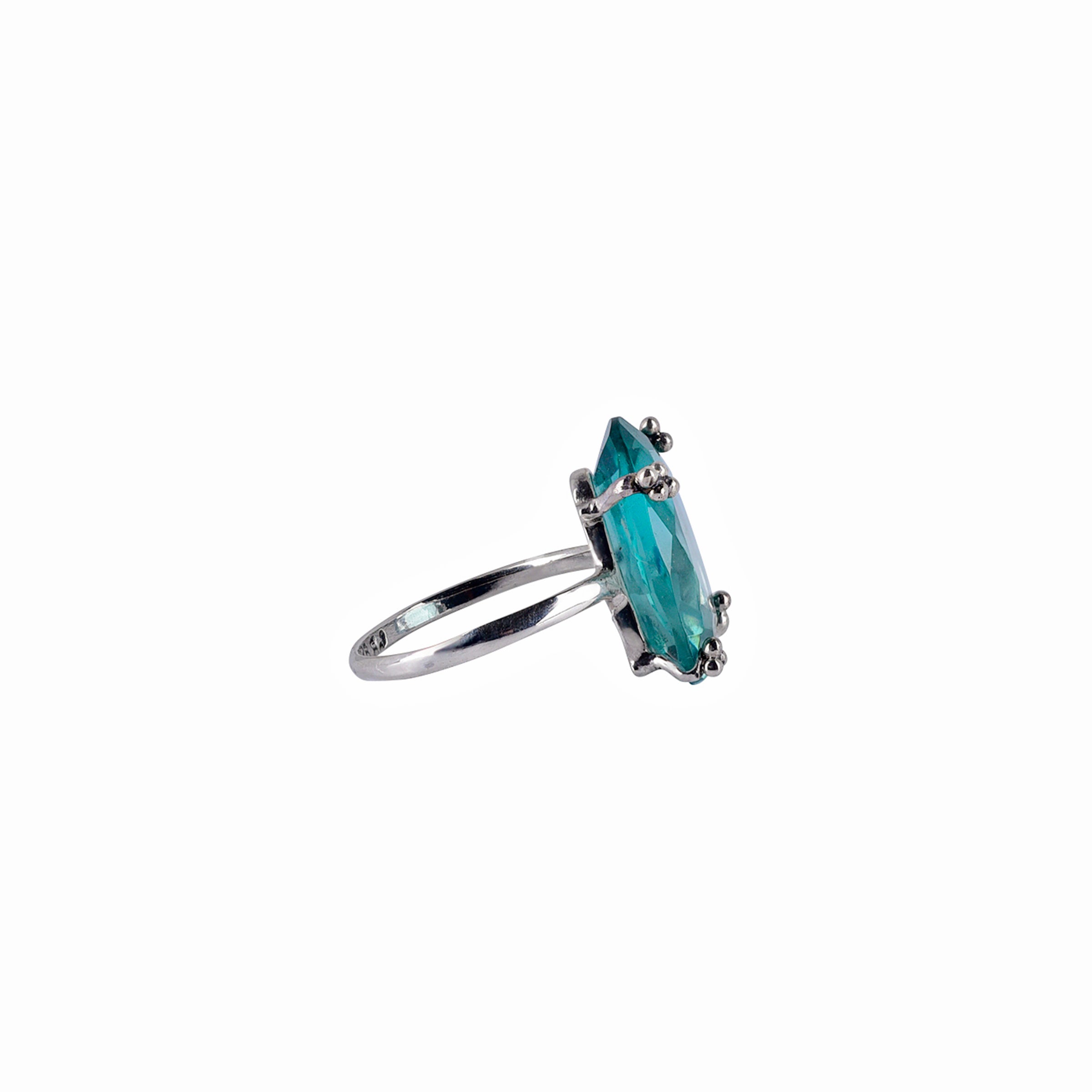 bright blue dyed aquamarine stone set in sterling silver with plain silver band ring side view