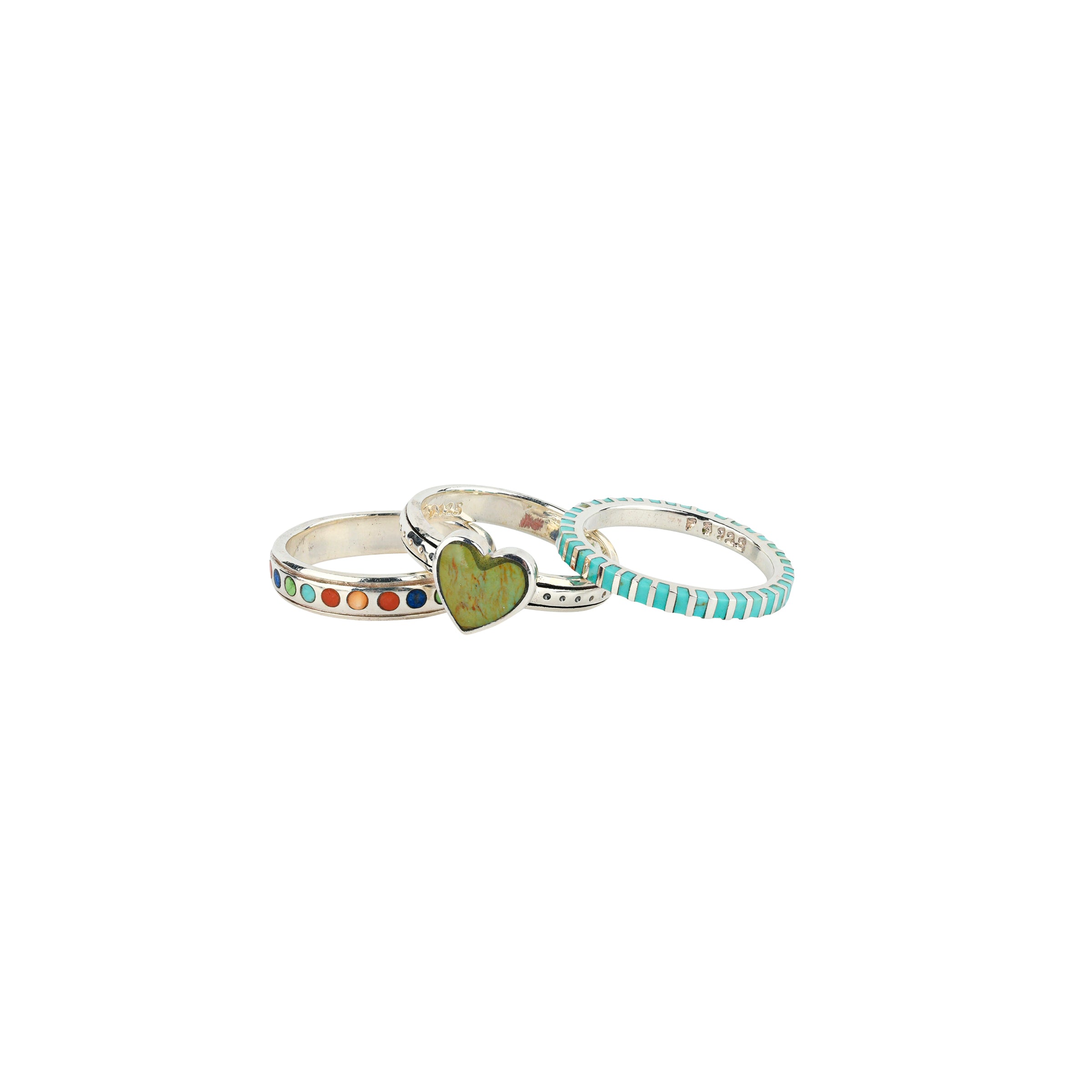 The Celebration of Love Stack Ring Set features a colorful band of dots of precious stones such as Coral, Spiny Oyster Shell, Lapis, and Turquoise. The middle band takes the cake with a perfect Green Turquoise Heart. And finally the top band is strips of Blue Turquoise set in Sterling Silver