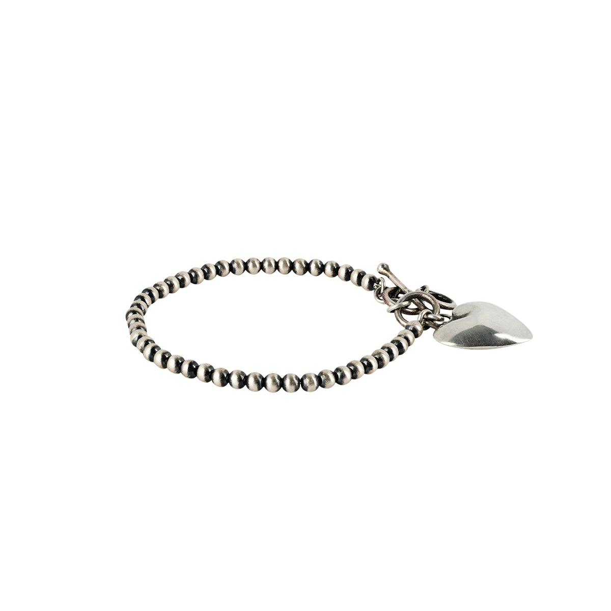 Sterling Silver charm bracelet strung with Desert Pearls and finished with a Sterling Silver heart charm 