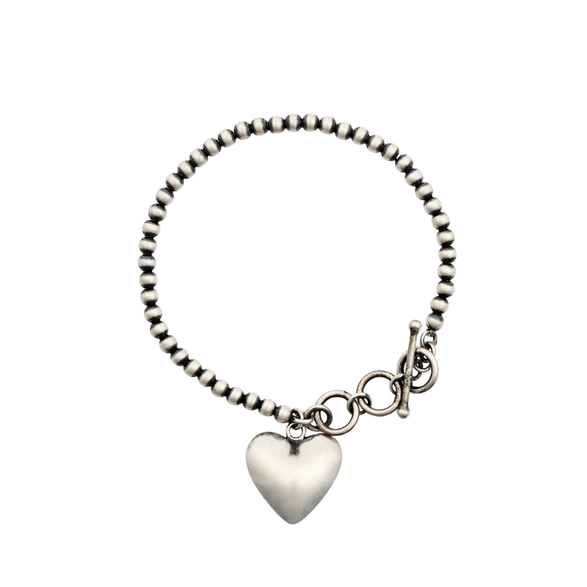 Sterling Silver charm bracelet strung with Desert Pearls and finished with a Sterling Silver heart charm 