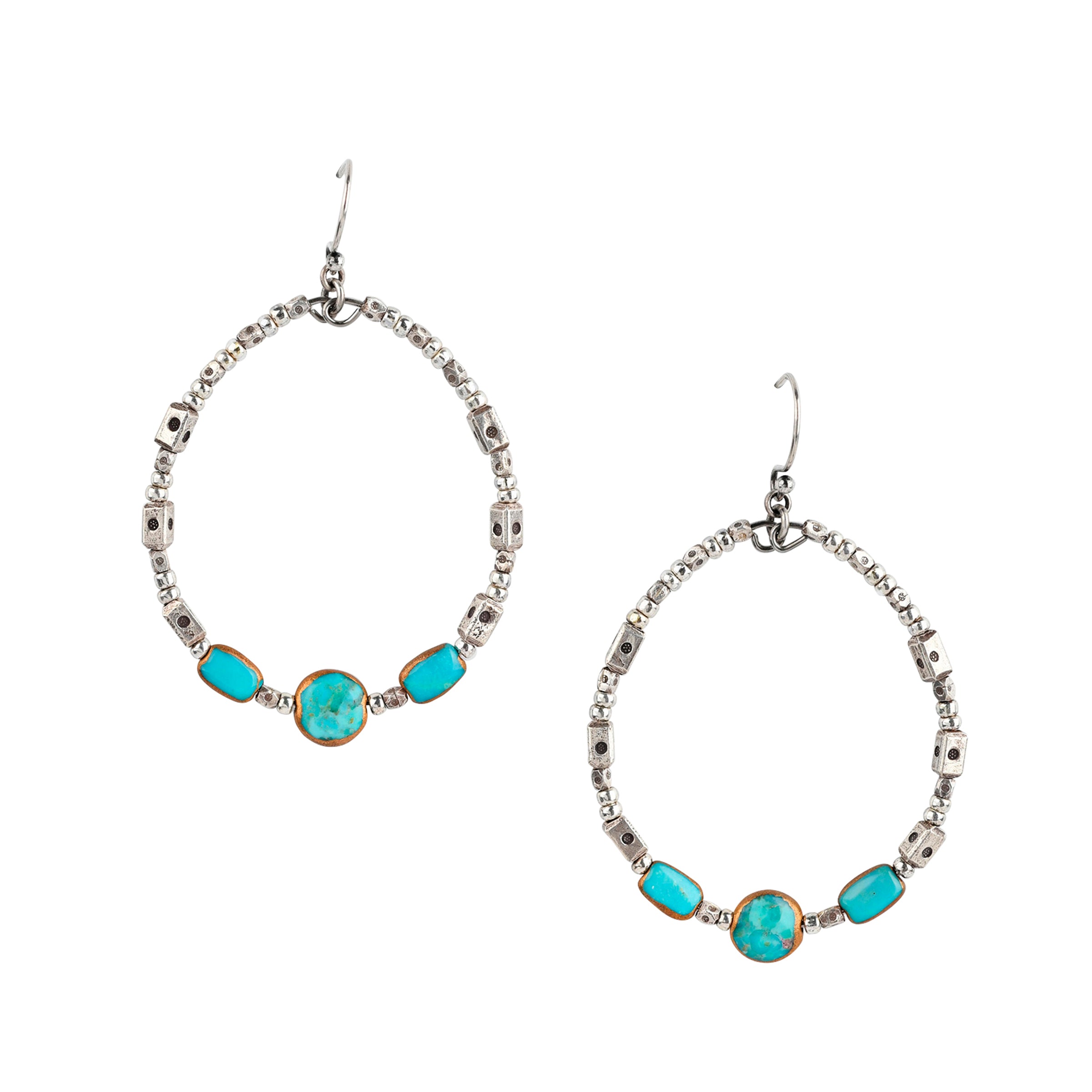 the See You Around Earrings are a gorgeous blend of mixed metals featuring stamped Sterling Silver Thai beading and electroplated Turquoise as the centerpiece. Set to face forward or swivel to the side, this earring will be loved at all angles.