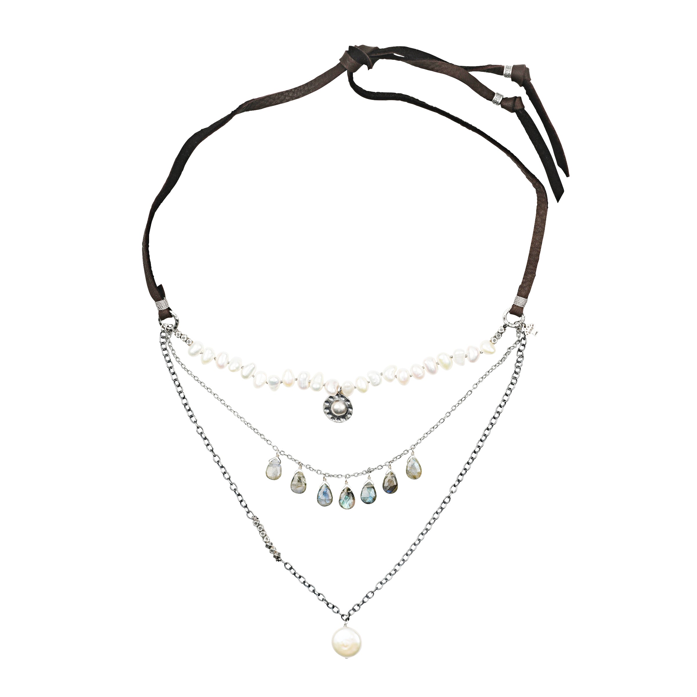 A three-strand layered necklace stung with tabs of Labradorite, a pendant of Freshwater Pearl, a string of Freshwater Pearl, all hung on soft deerskin leather.