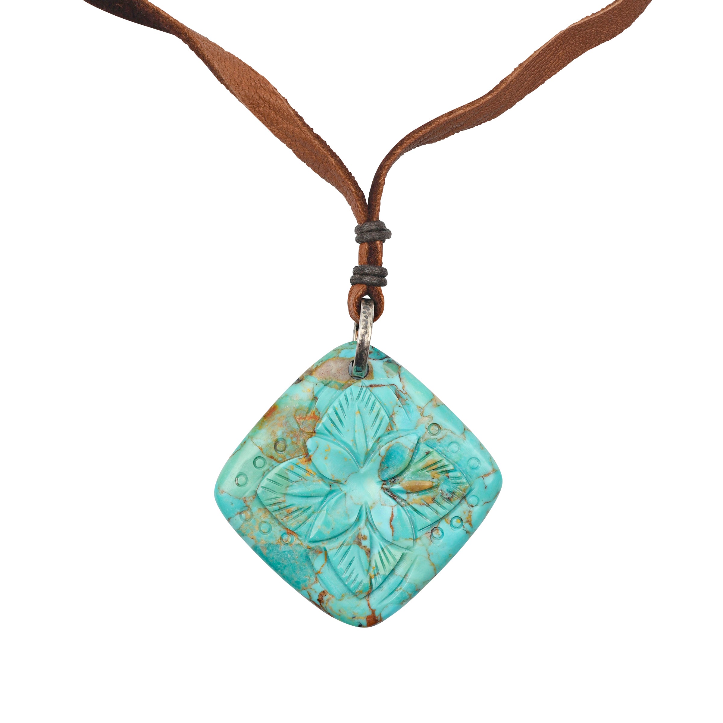 Carved Turquoise Pendant strung on soft deerskin leather finished with a Sterling Silver slider for an adjustable fit
