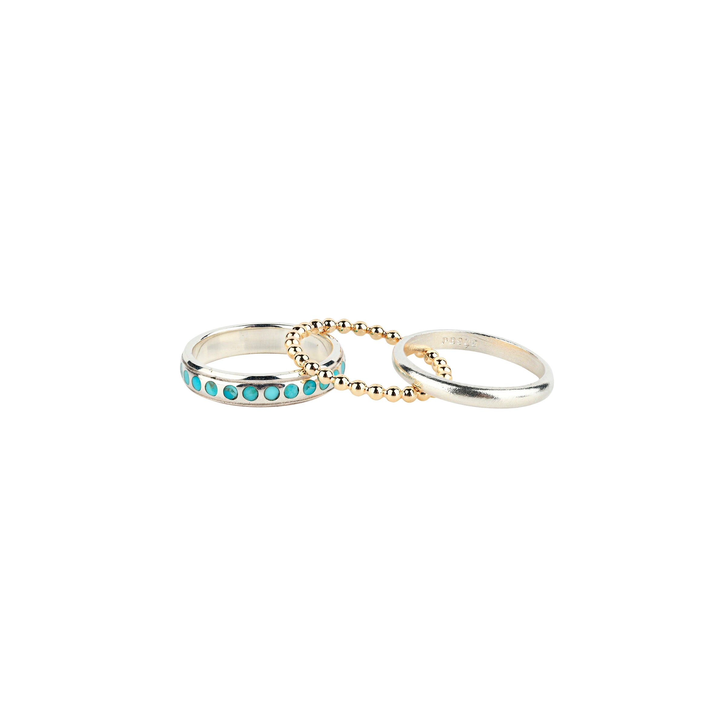 This set is comprised of three rings, meant to be stacked in any combination. Featuring a dotted Sterling Silver band with inlayed Turquoise, a plain Sterling Silver band, and finally a textured 14k Gold Plate band.