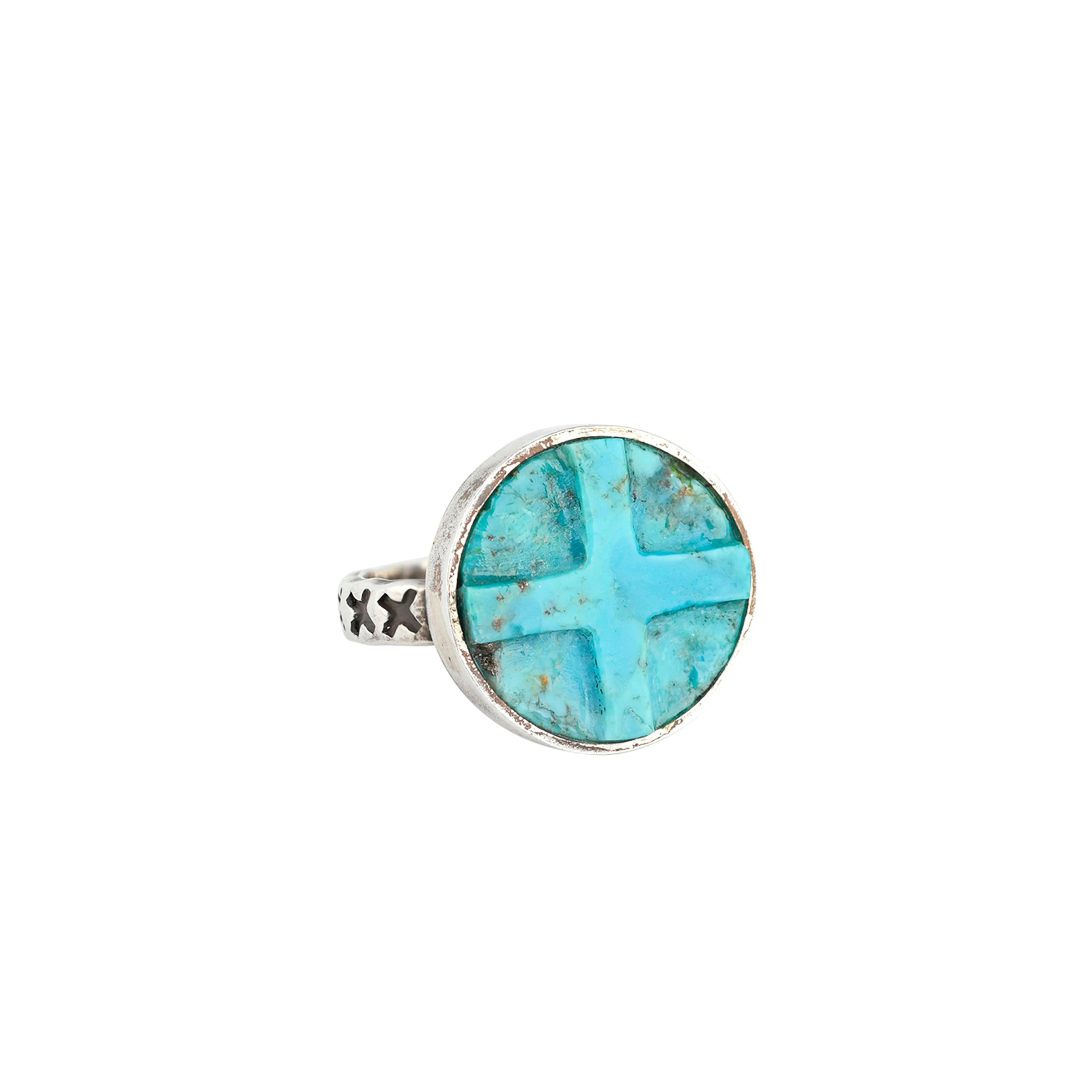 A carved, square cross in a circle of Blue Turquoise set in stamped Sterling Silver