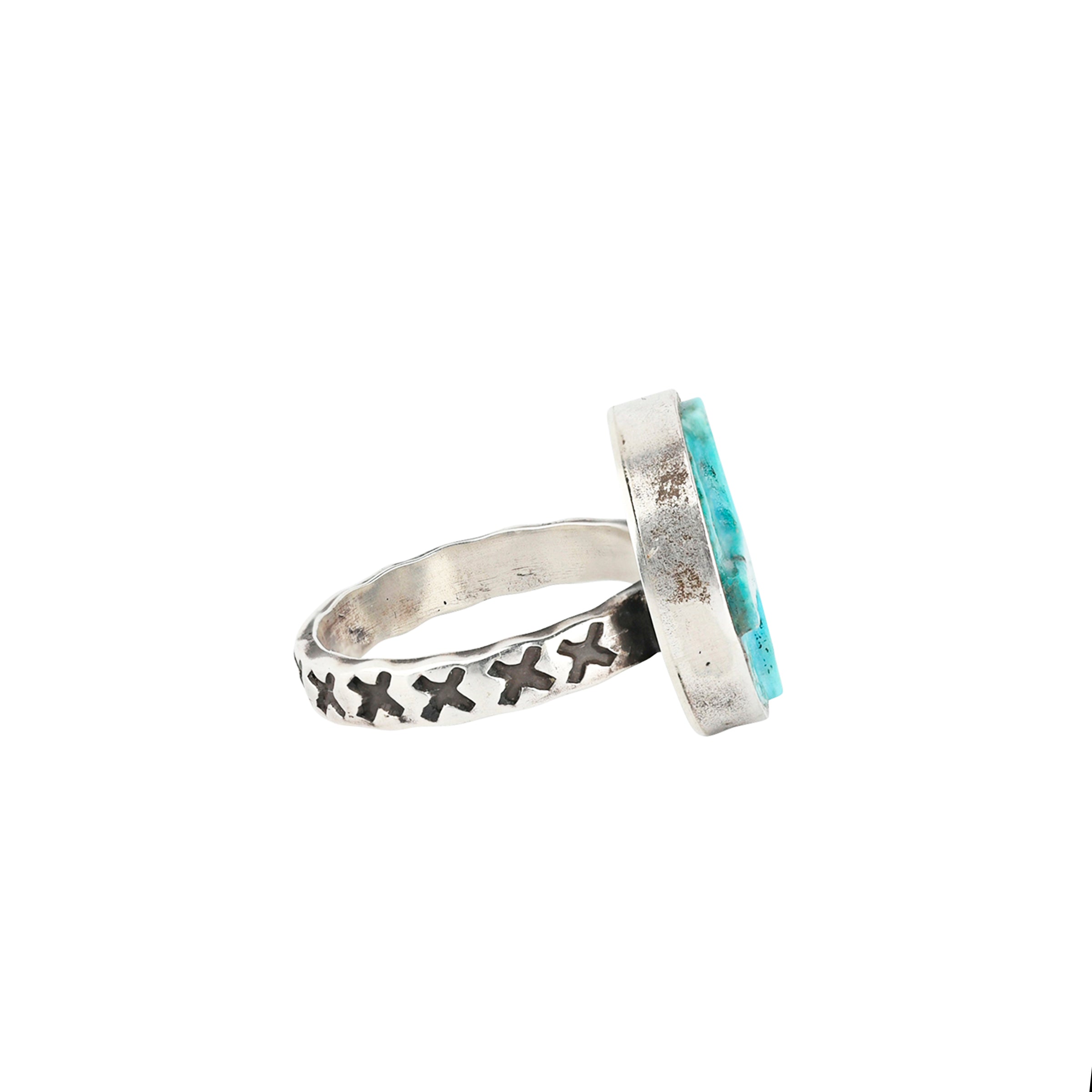A carved, square cross in a circle of Blue Turquoise set in stamped Sterling Silver
