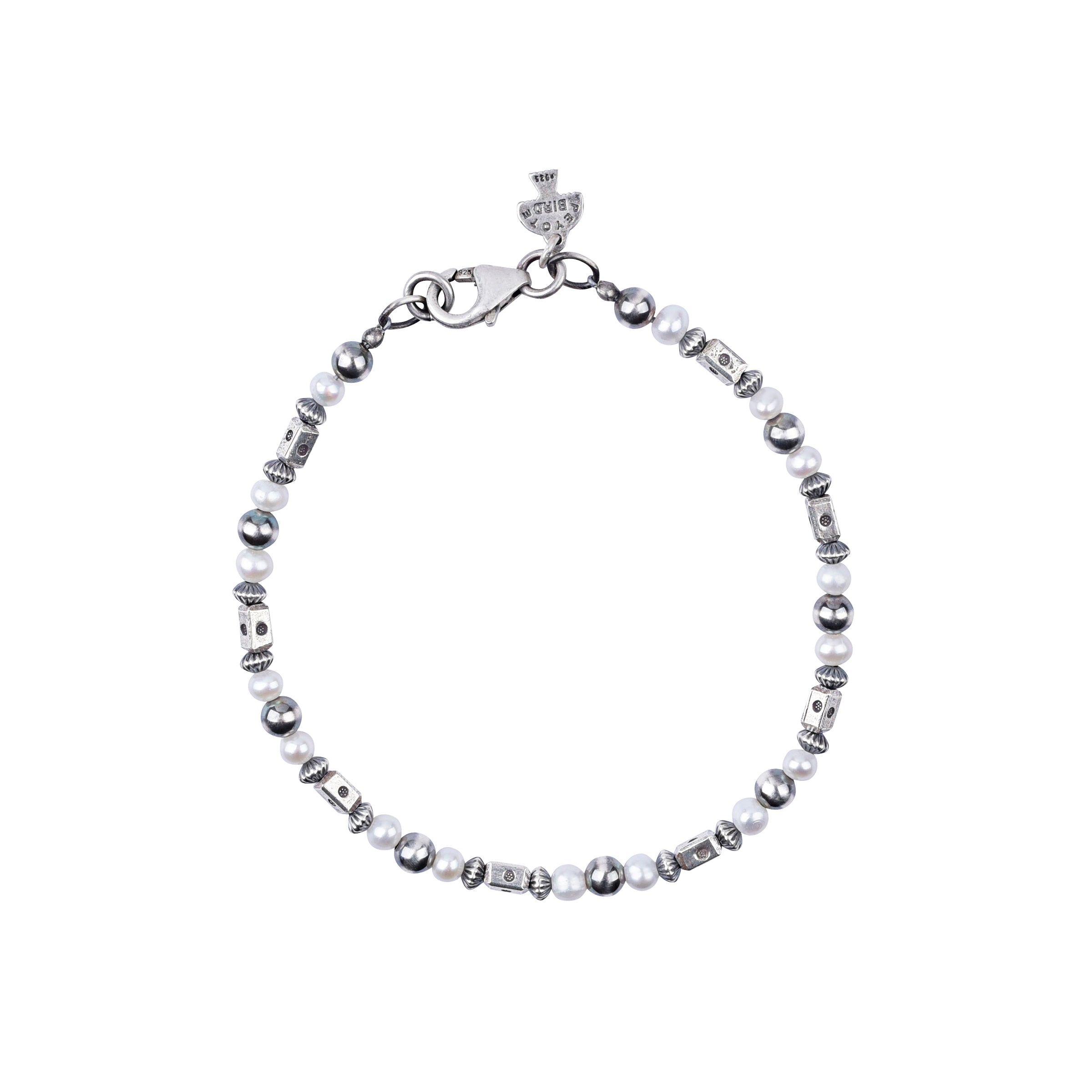 Our O'Keeffe Bracelet is adorned with desert pearls, sterling silver embellishments, and your choice of coral, pearl, or turquoise beading, or stick with just sterling silver!