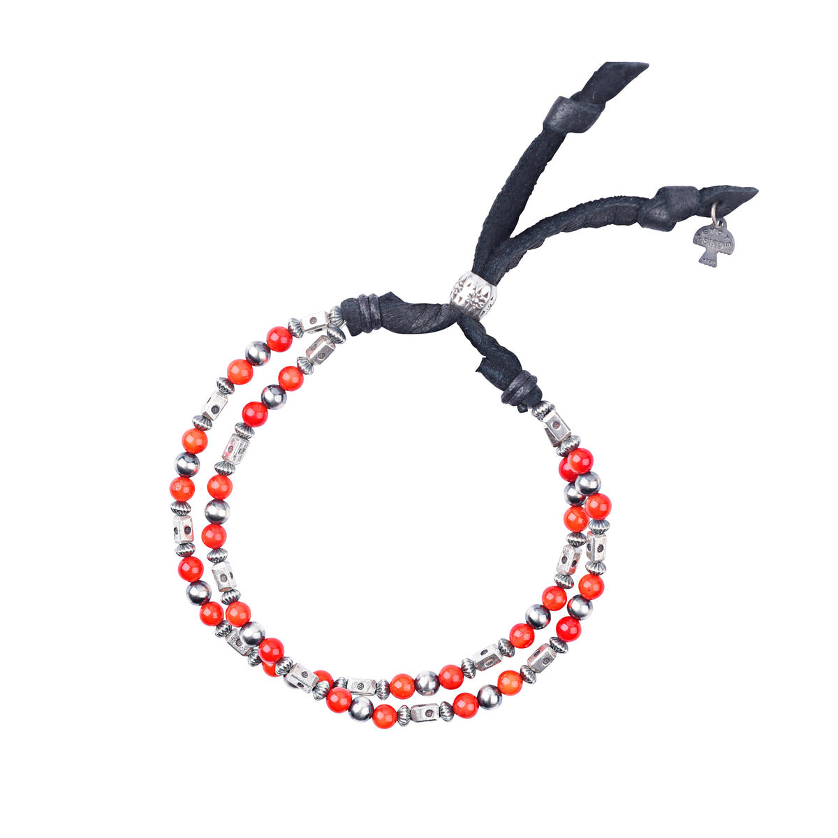 An adjustable bracelet featuring deerskin leather, desert pearls, sterling silver accents and beading, topped off with coral