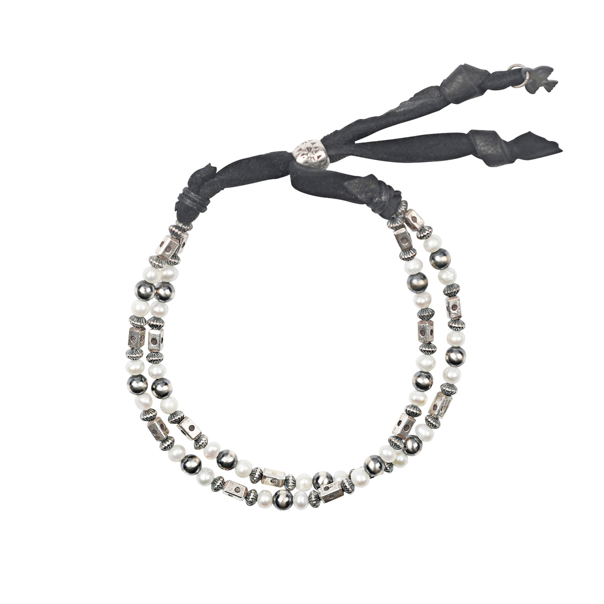 An adjustable bracelet featuring deerskin leather, desert pearls, sterling silver accents and beading, topped off with mother of pearl beads.