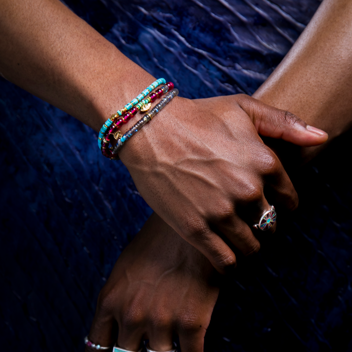 A bracelet with gold plate and blue turquoise beads, featuring a bold pattern and a gold plate clasp.