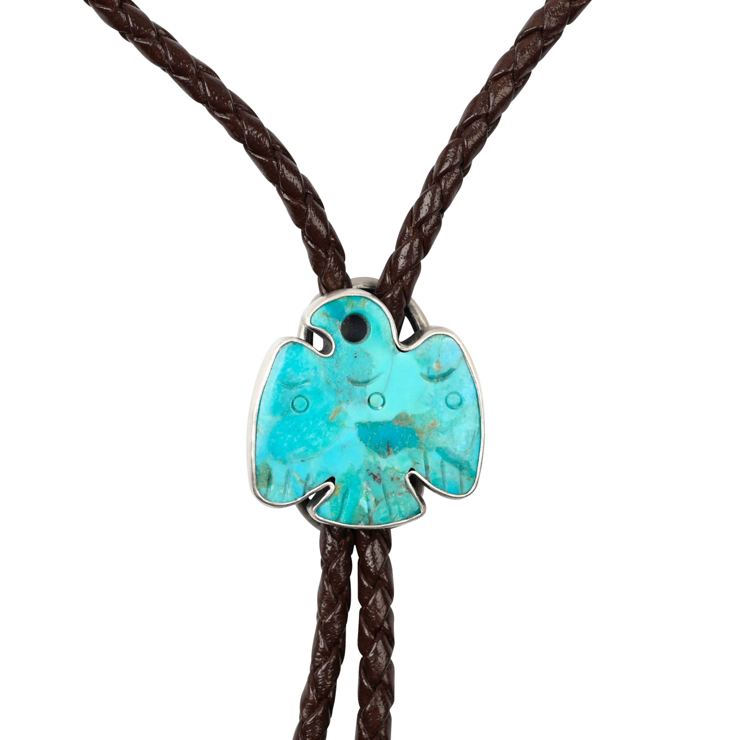 This bolo features a Thunderbird carved from Blue Turquoise in Sterling Silver. Strung on brown braided leather and finished with Sterling Silver tips.