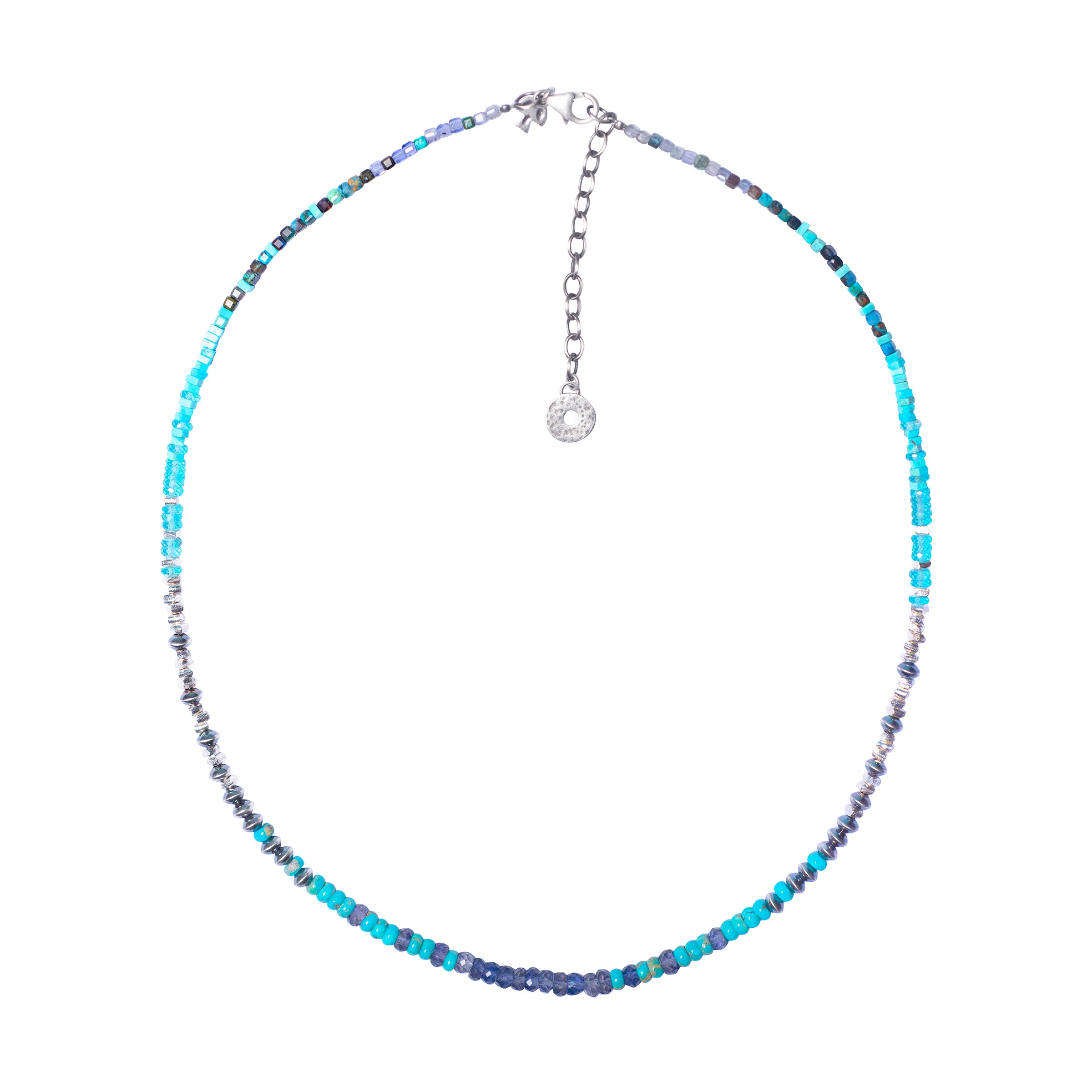 A Peyote Bird Original necklace, made in Santa Fe, NM. The Midnight Cowboy necklace features Emerald Valley Blue Turquoise, sterling silver, apatite, iolite, and chrysocolla. Made in USA.