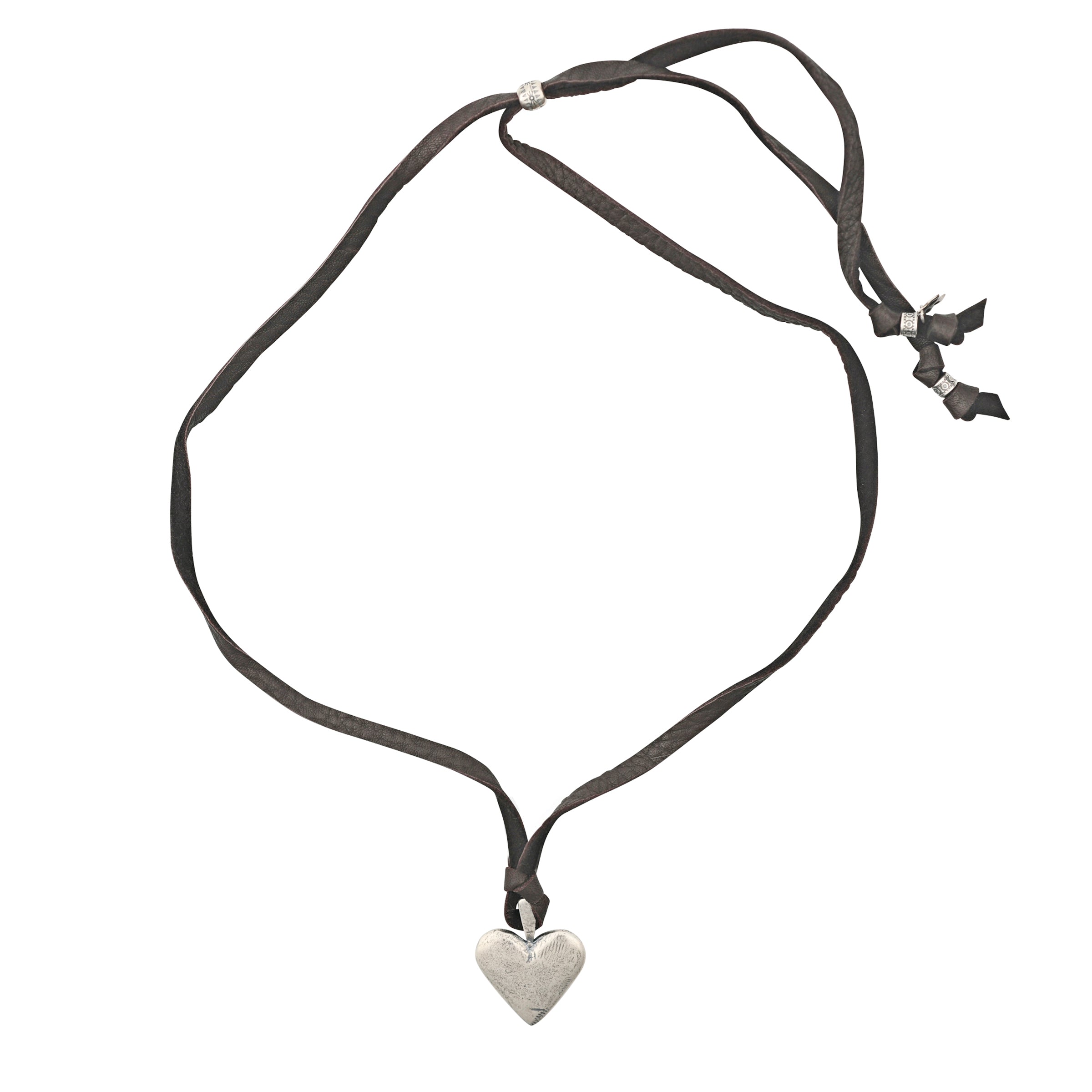 A strong, Sterling Silver Heart Pendant strung on soft, brown deerskin leather finished with a Sterling Silver slider bead for an adjustable fit.