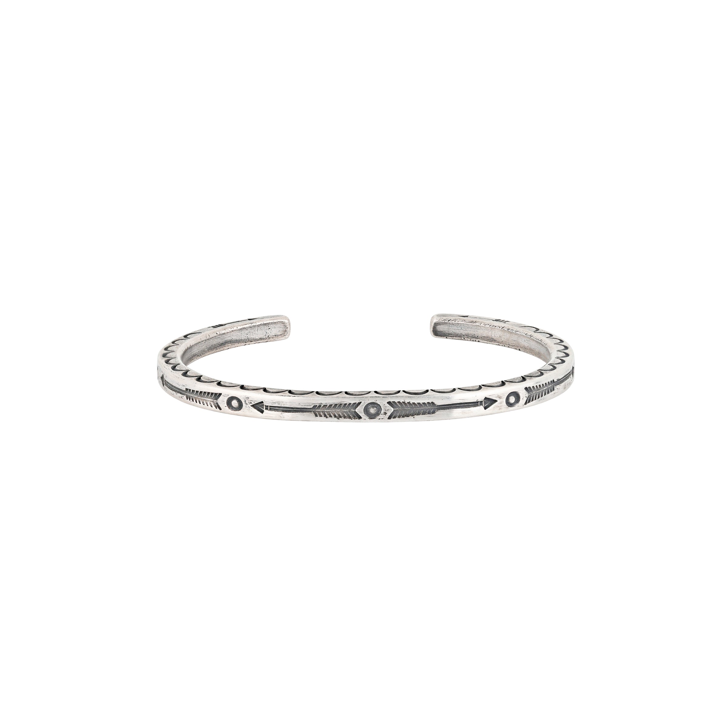 A slim Ingot Coin Silver, handmade stamped cuff with arrows and Southwestern motif detailing
