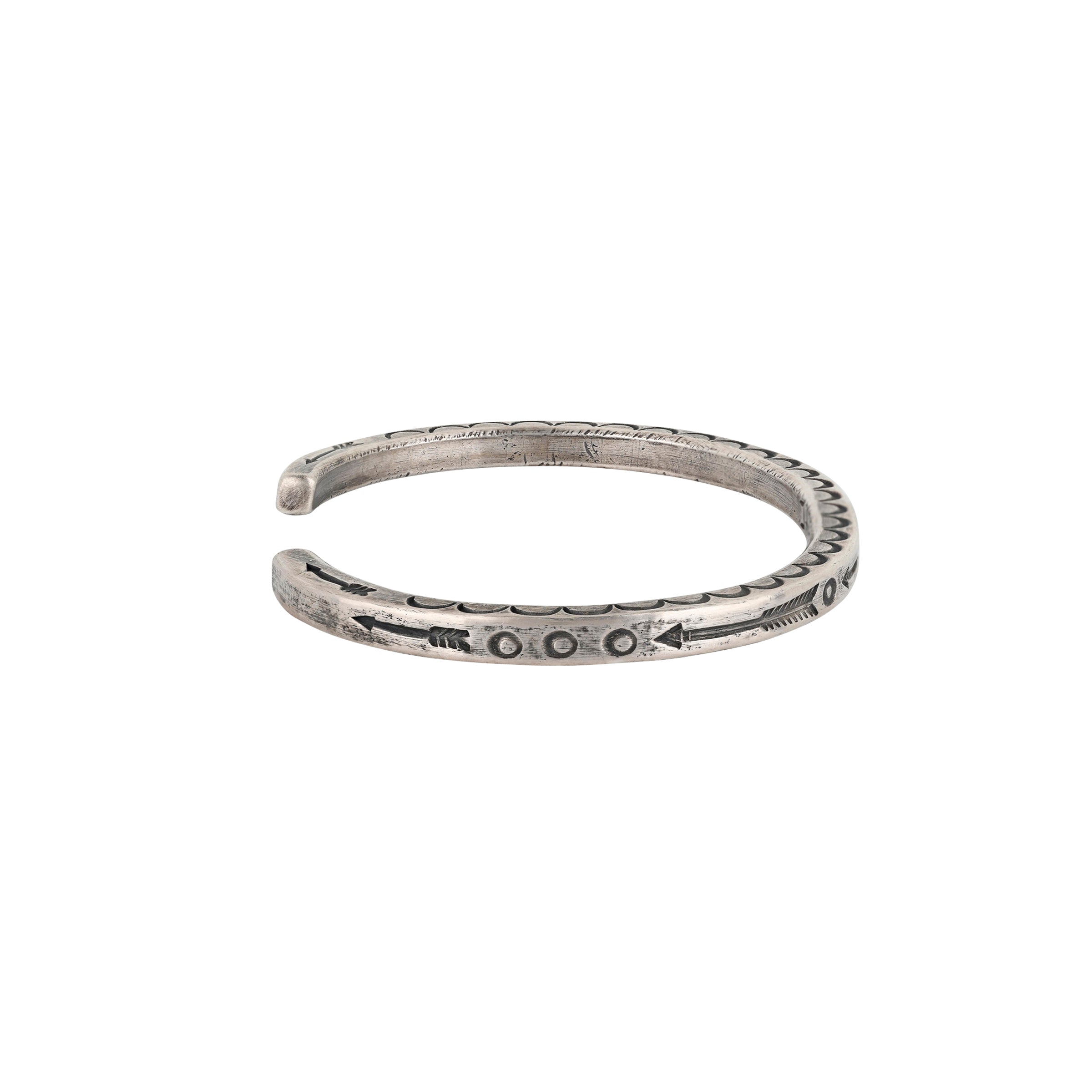 A slim Ingot Coin Silver, handmade stamped cuff with arrows and Southwestern motif detailing