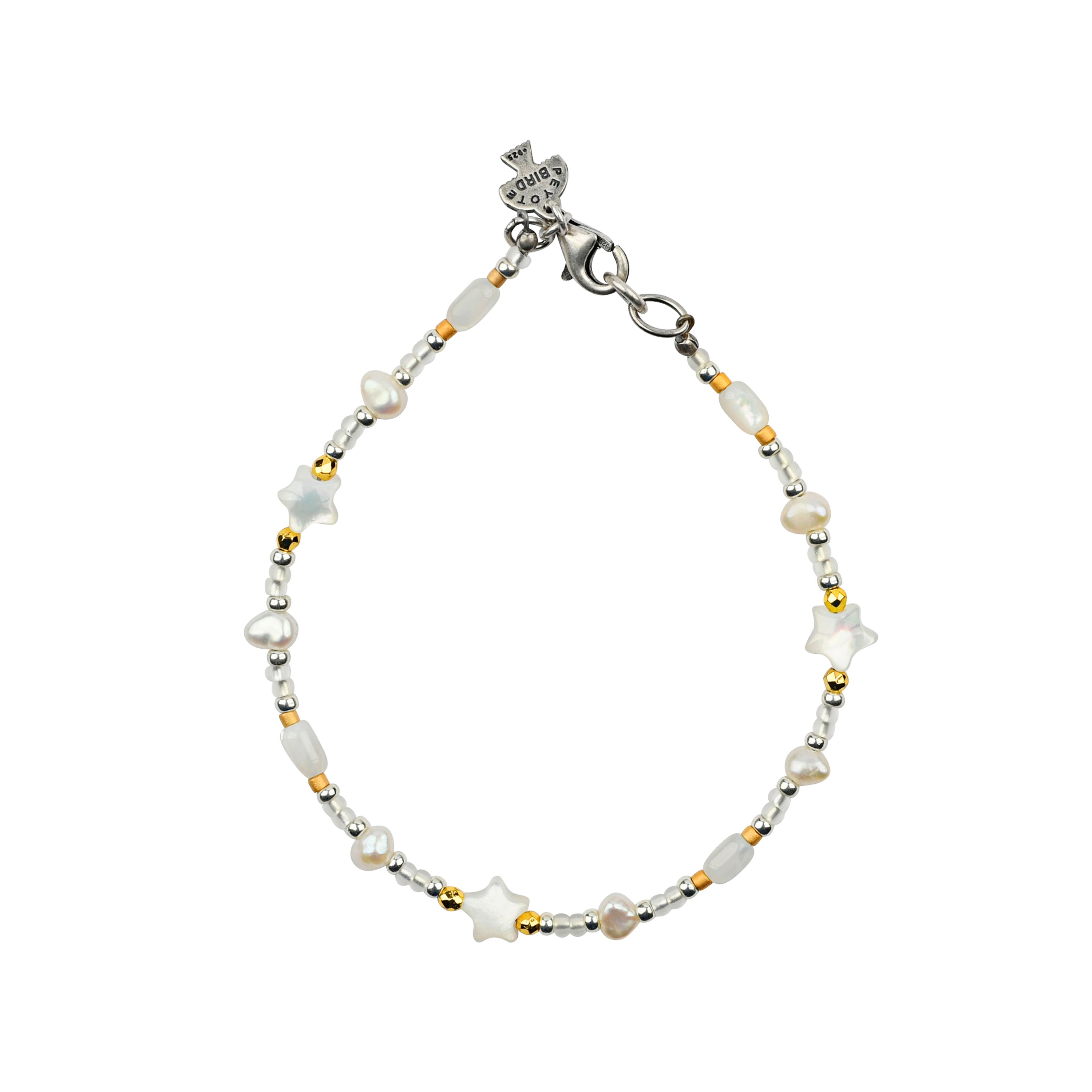 Beaded bracelet in white tones with gold pops of color and star beads with sterling silver lobster claw clasp. 