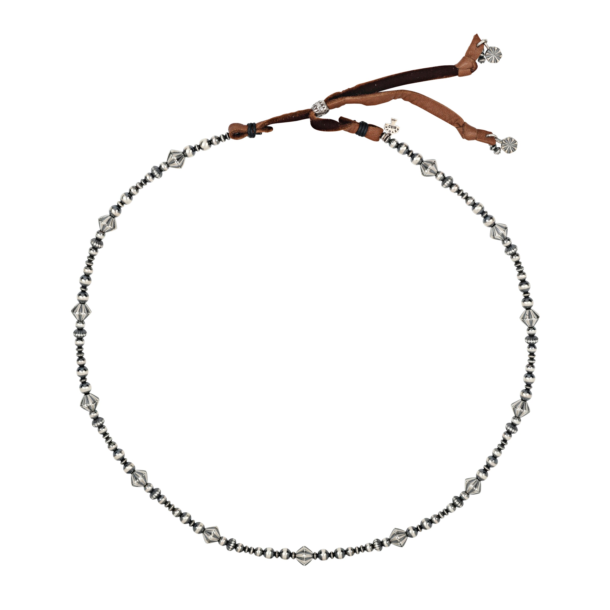 Sterling silver beads in various shapes, textures and patinas strung with brown deerskin leather slider bead closure and charm details. 