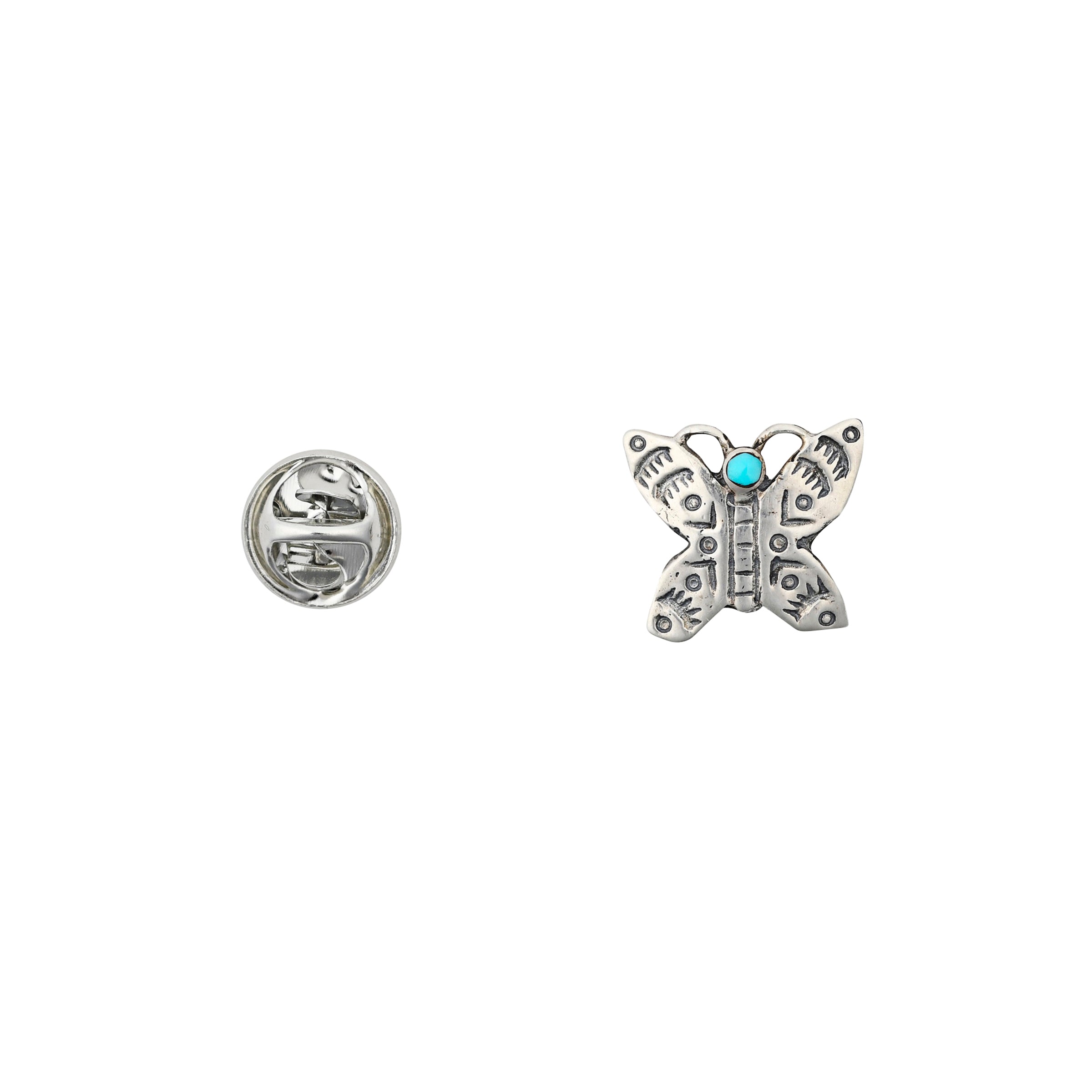Sterling silver butterfly pin with turquoise head and detailed stamp work next to pin back. 
