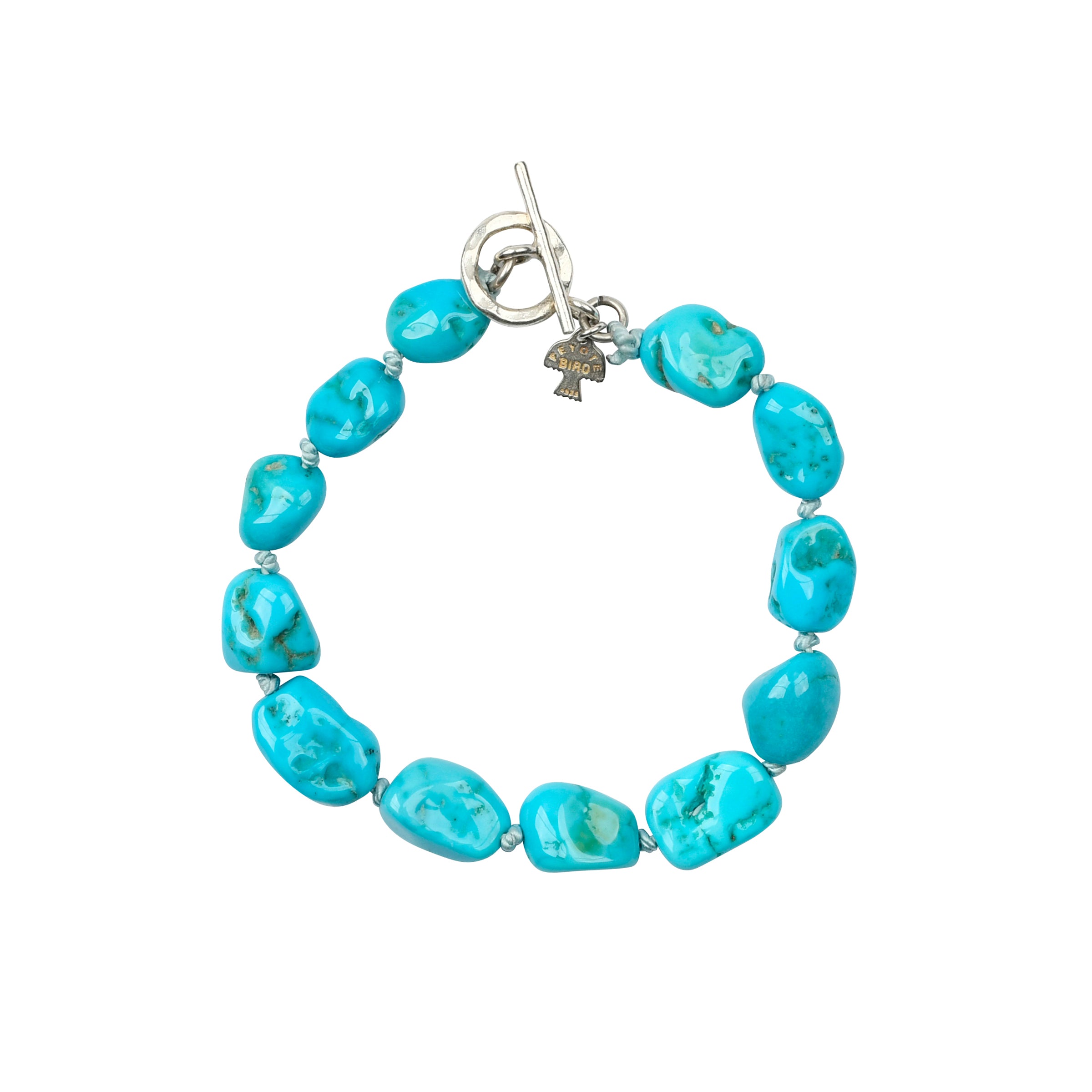 Large turquoise nugget beads with knotted silk thread inbetween for bracelet with sterling silver toggle closure. 