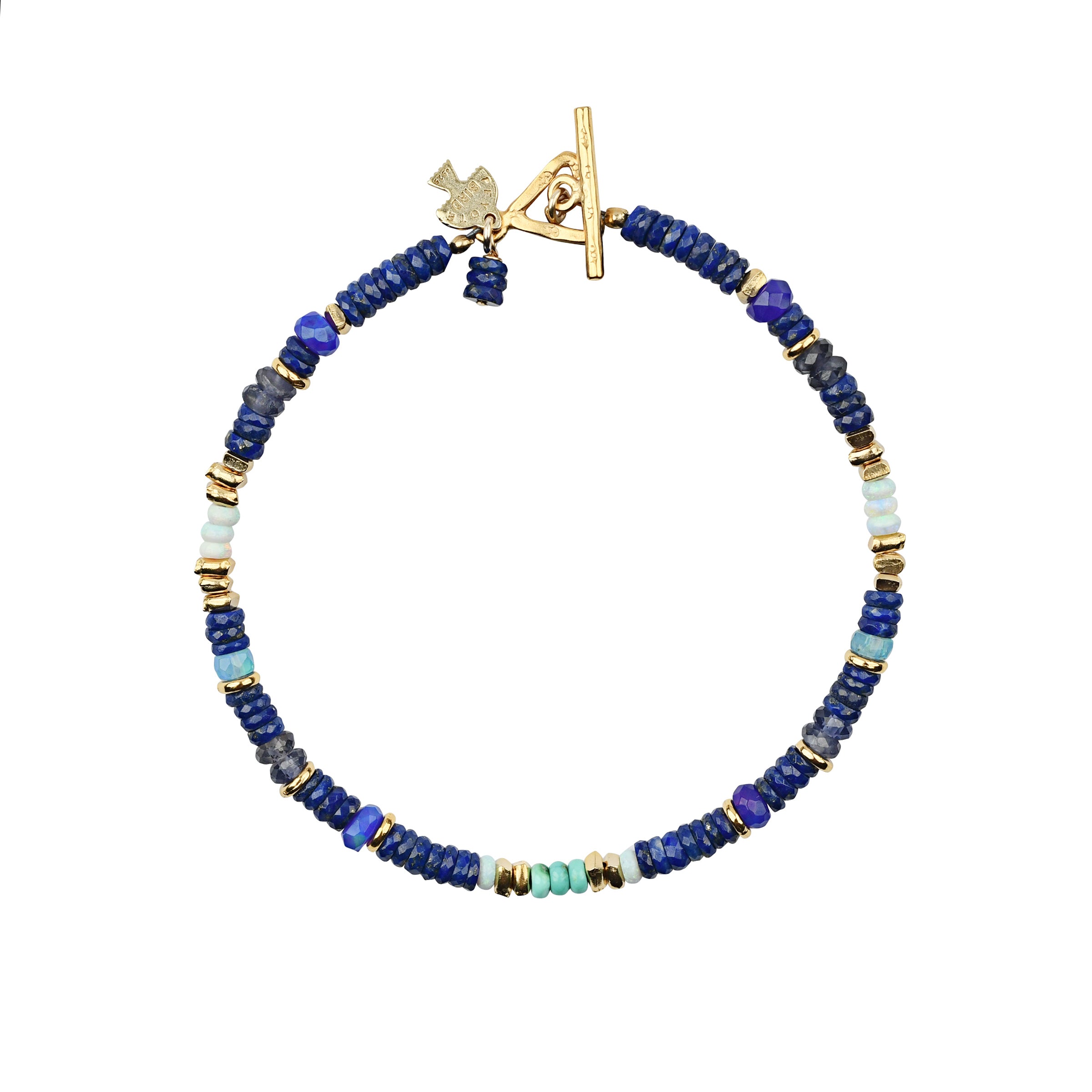 Beaded bracelet in blue tones and pops of turquoise and opal with gold beads throughout and gold toggle closure. 