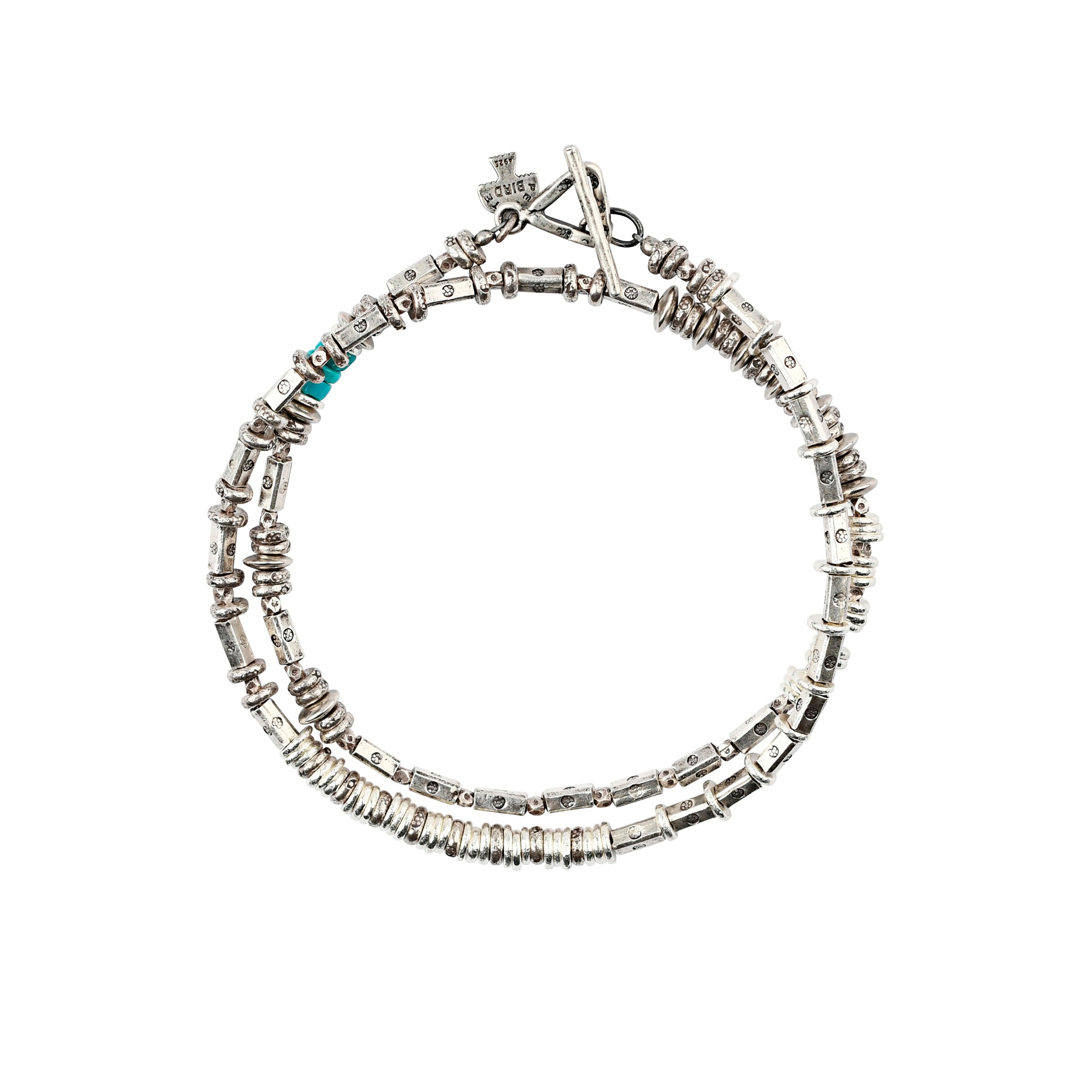 The Patina Wrap Bracelet is comprised of sterling silver and a pop of turquoise. 