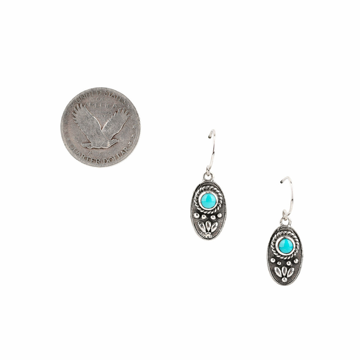 Sterling silver oval shaped dangle earrings with added silver design elements and blue turquoise stones at the top.