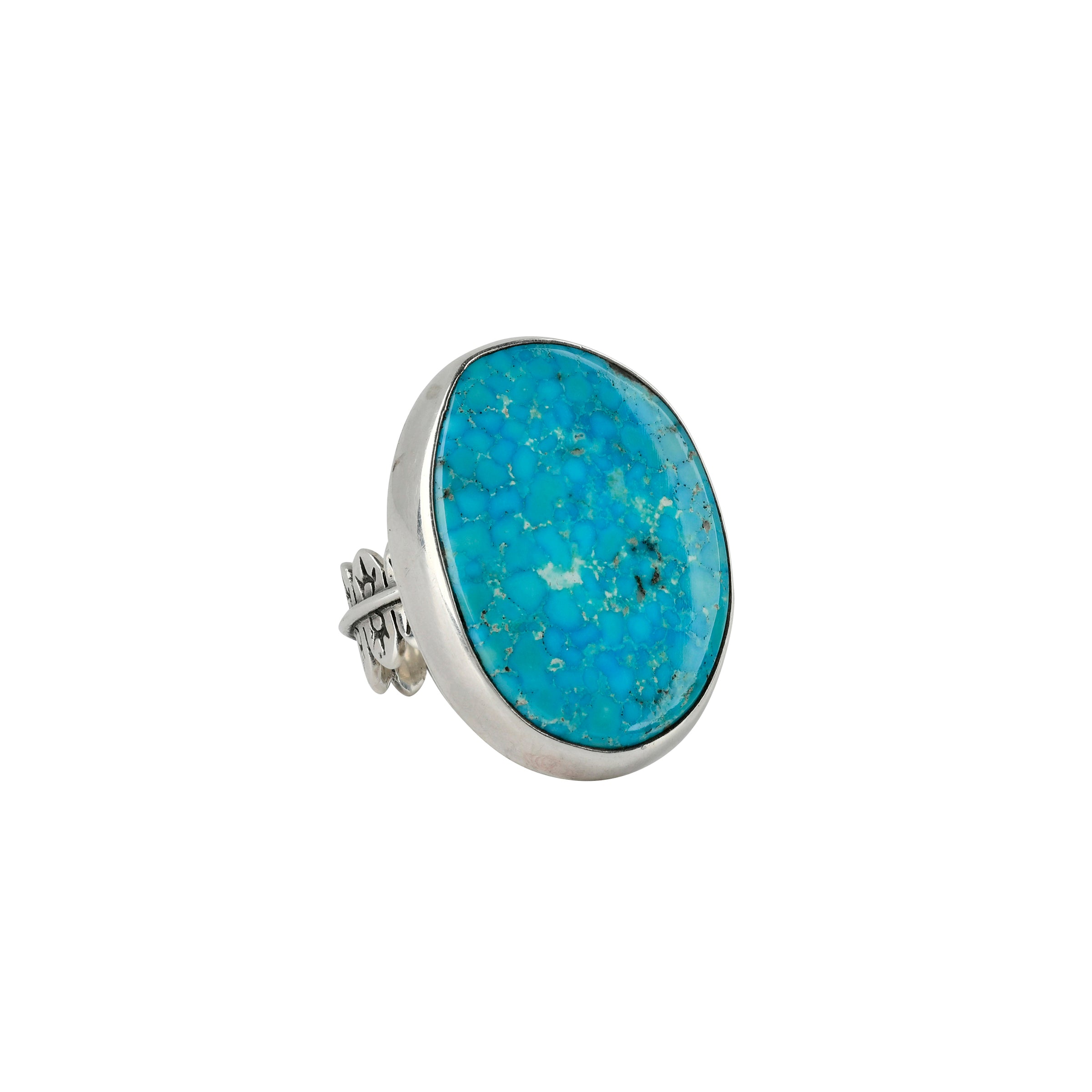 Round shaped turquoise stone ring set in sterling silver with detailed band. 