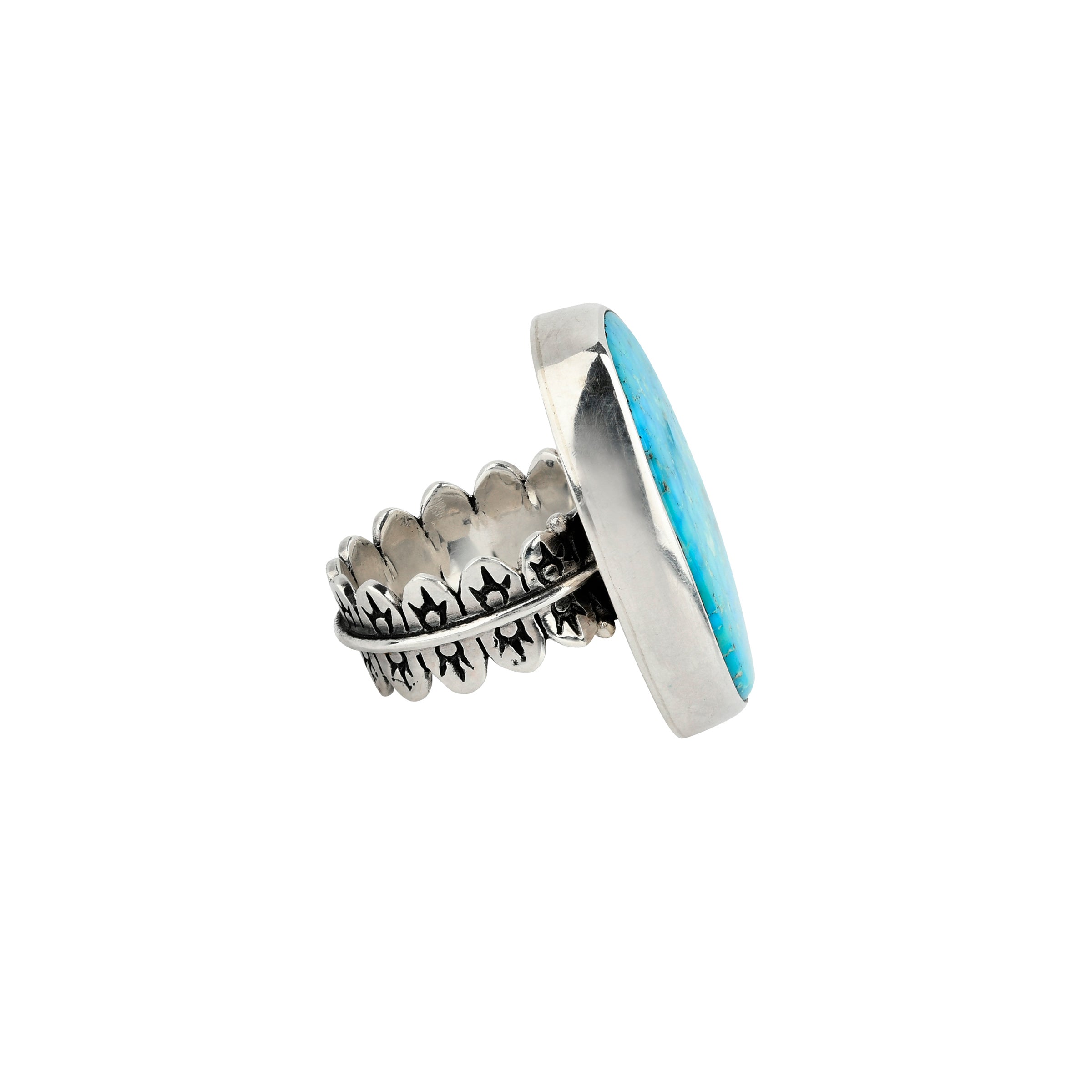 Round shaped turquoise stone ring set in sterling silver with detailed band side view. 