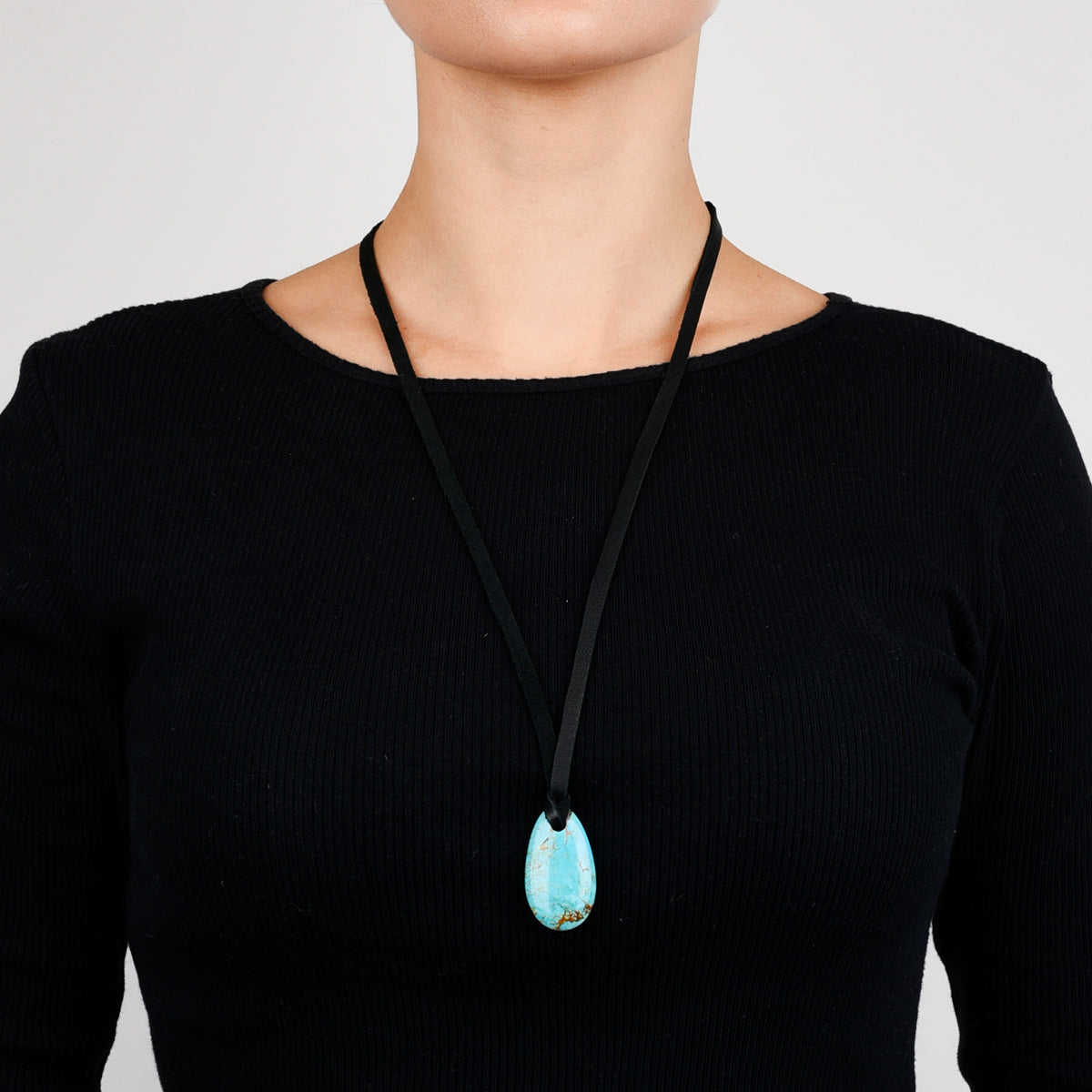Turquoise stone necklace on deerskin leather. 
