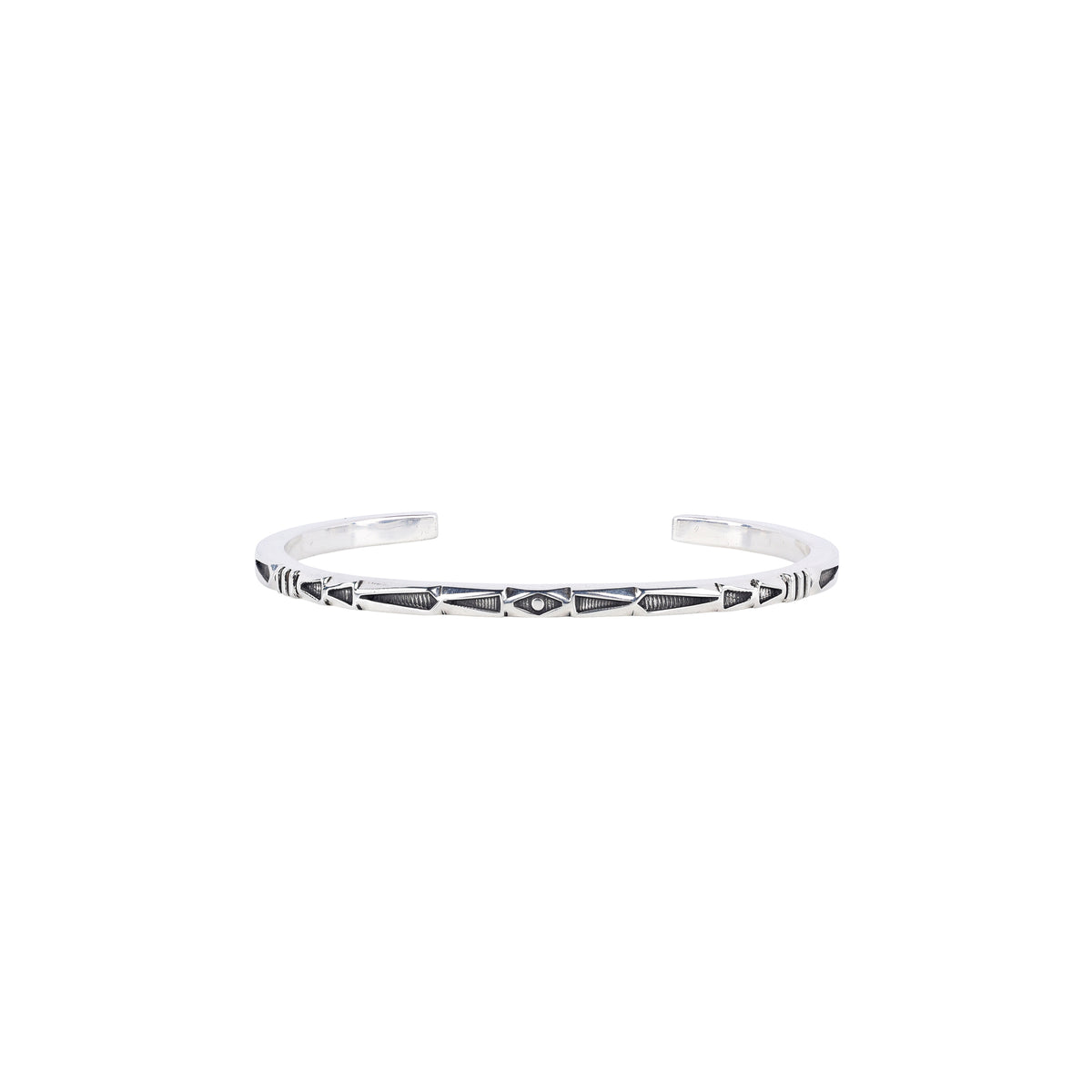 A sterling silver cuff bracelet with geometric patterns and stamping. 