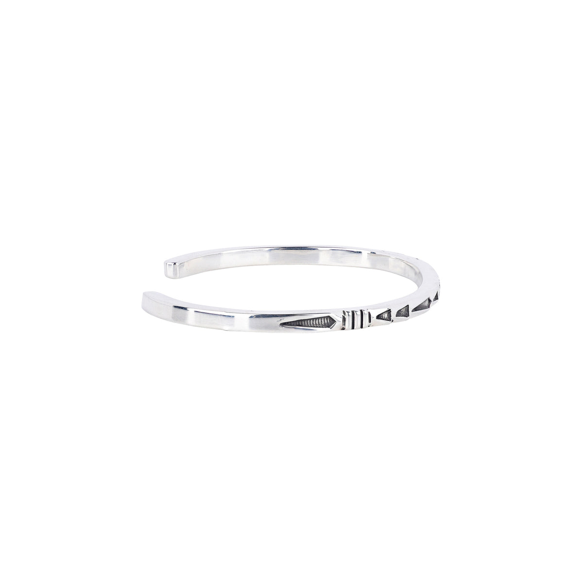 A sterling silver cuff bracelet with geometric patterns and stamping. 