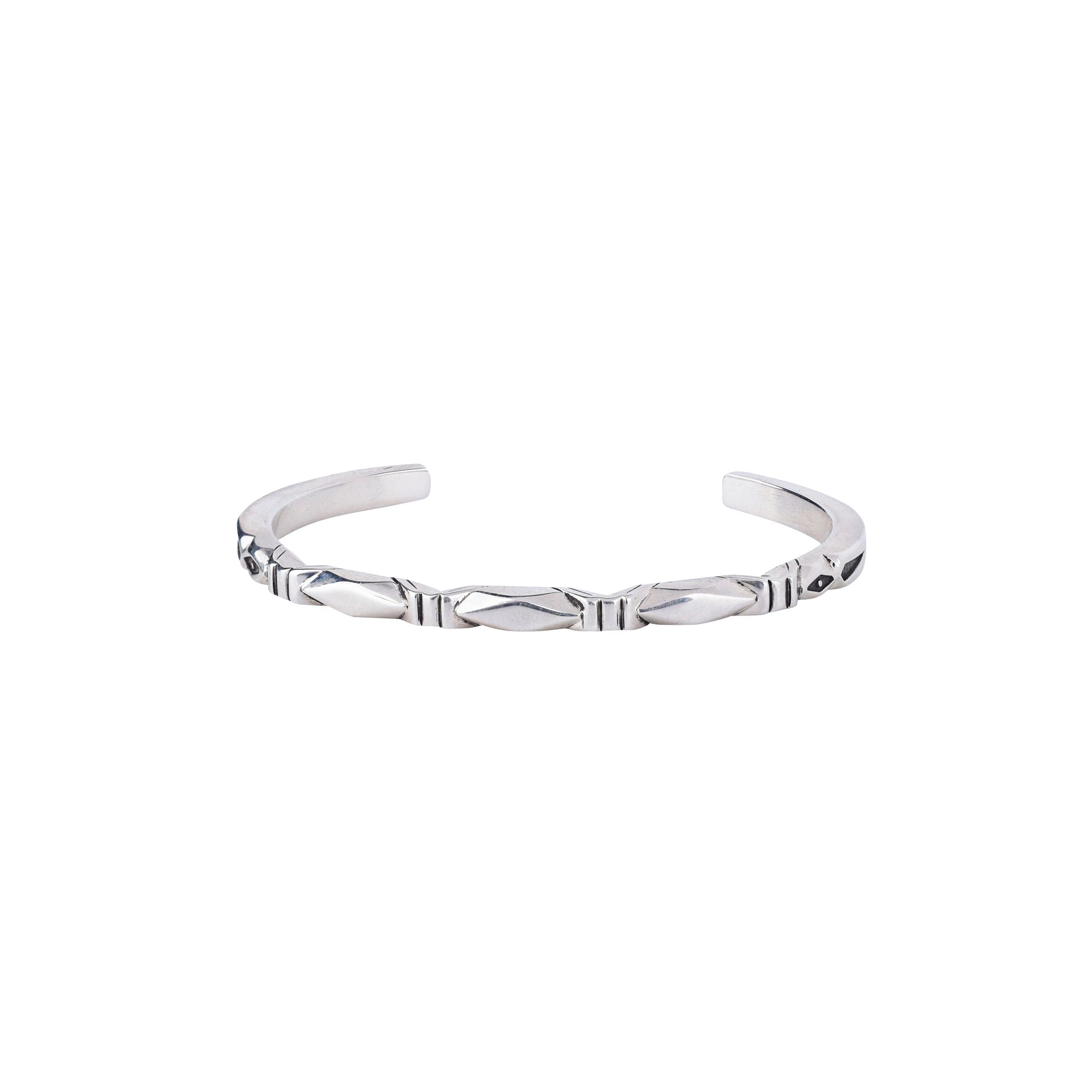 A sterling silver cuff bracelet with a geometric pattern.