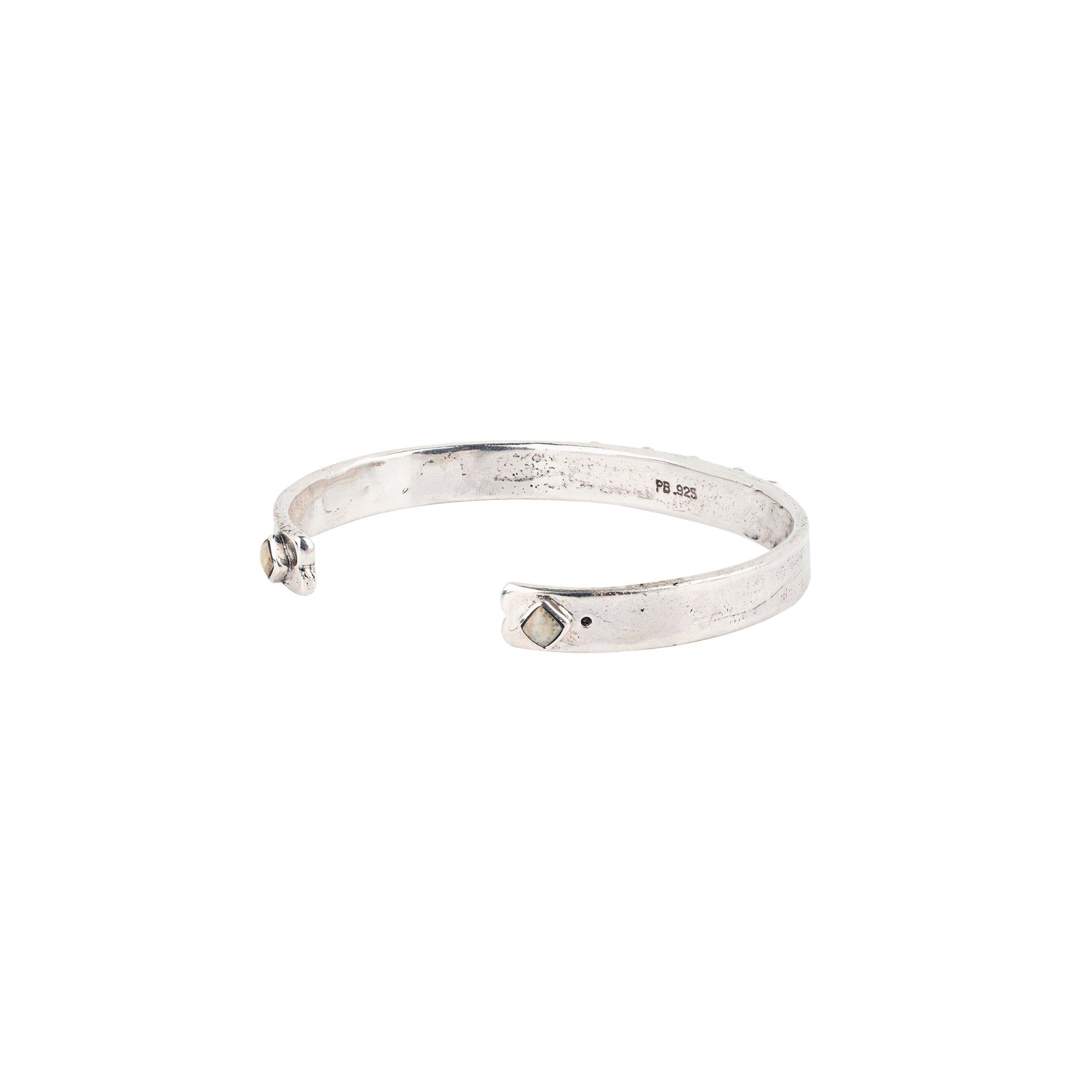 Vintage inspired cuff from our nomad collection that features sterling silver with diamond shaped petrified wood.