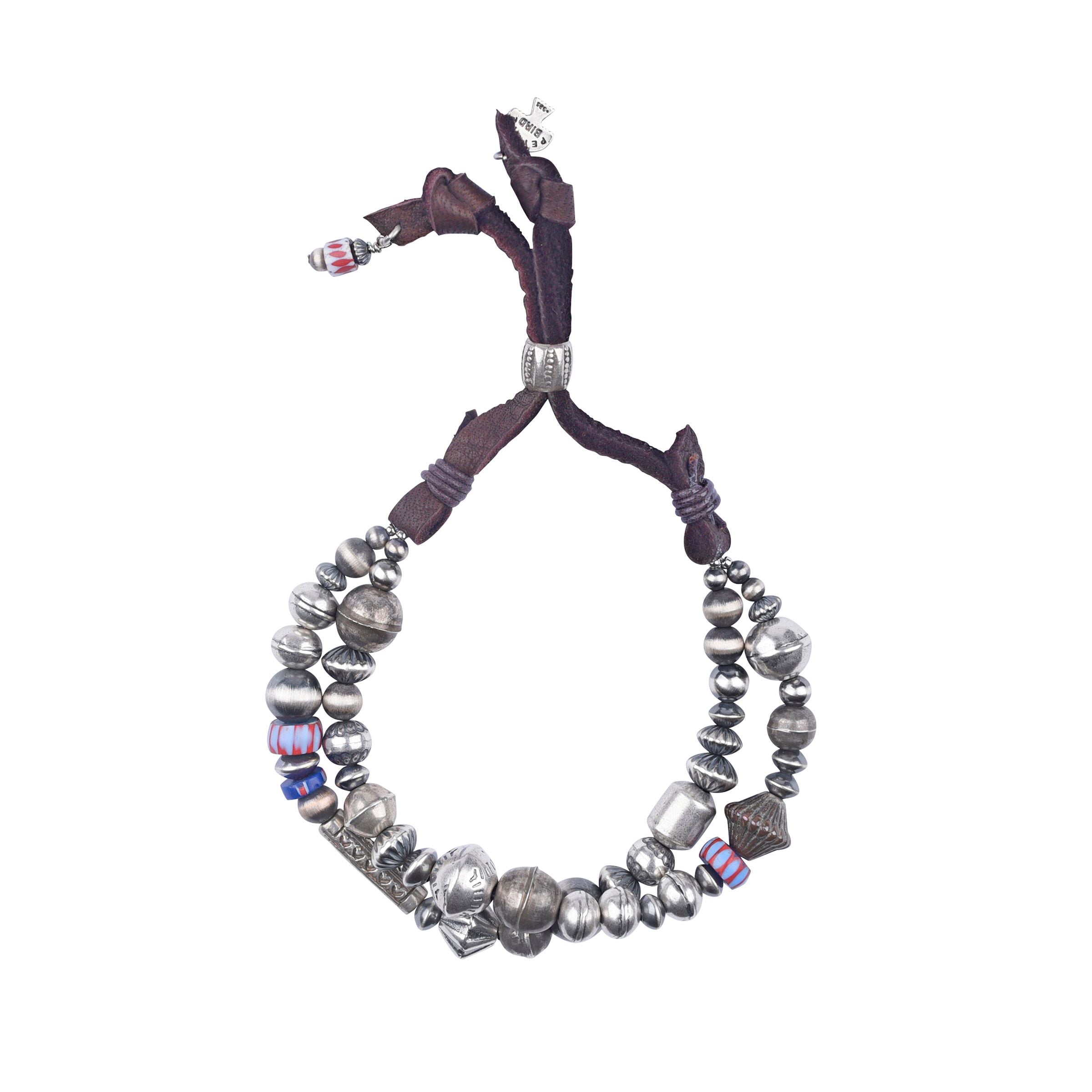 An adjustable deerskin leather bracelet with a mix of vintage beads, desert pearls, and trade beads, featuring a silver clasp.