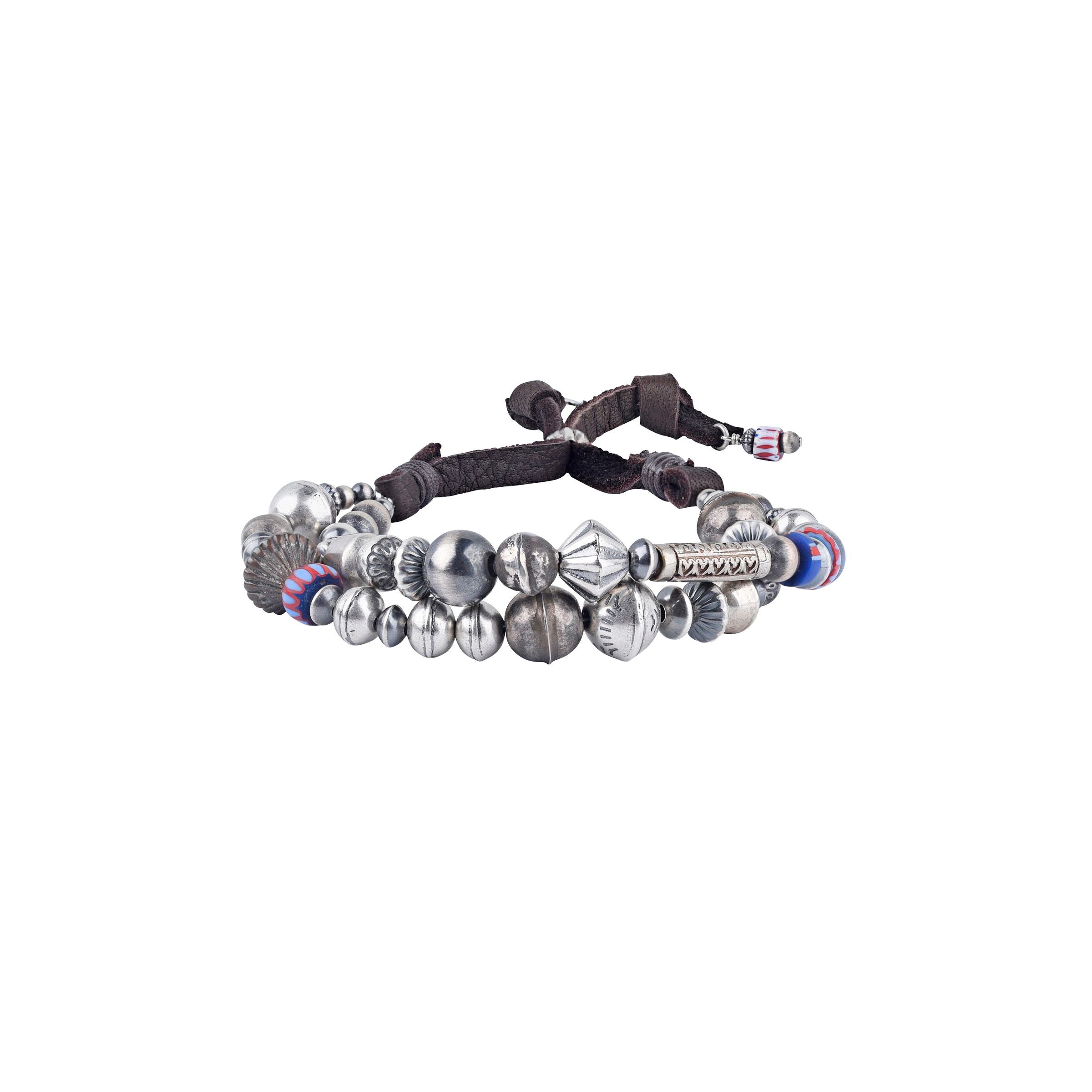 An adjustable deerskin leather bracelet with a mix of vintage beads, desert pearls, and trade beads, featuring a silver clasp.