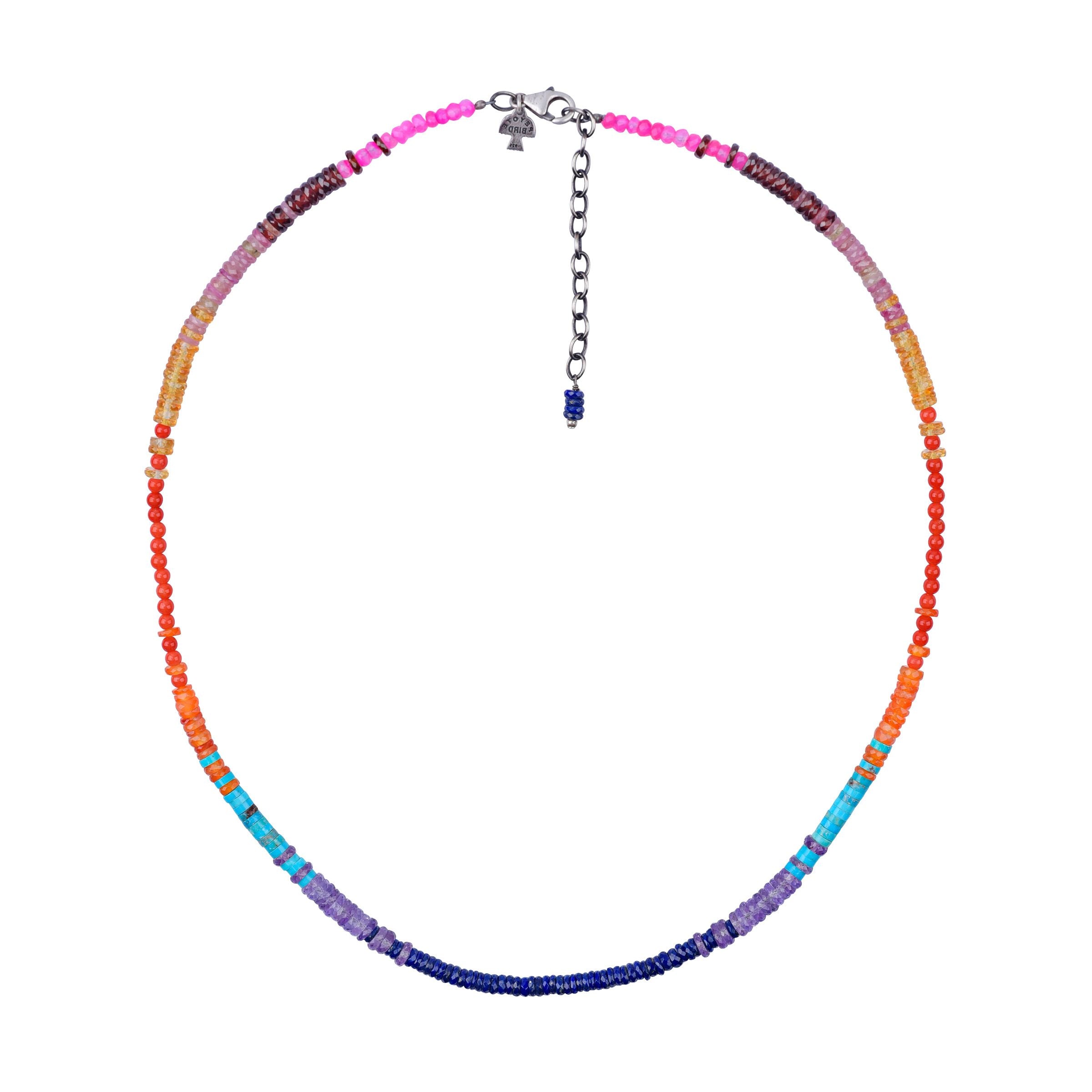 A Peyote Bird original necklace with a sterling silver chain, blue turquoise, amethyst, carnelian, lapis, red & orange coral, and chalcedony beads.  