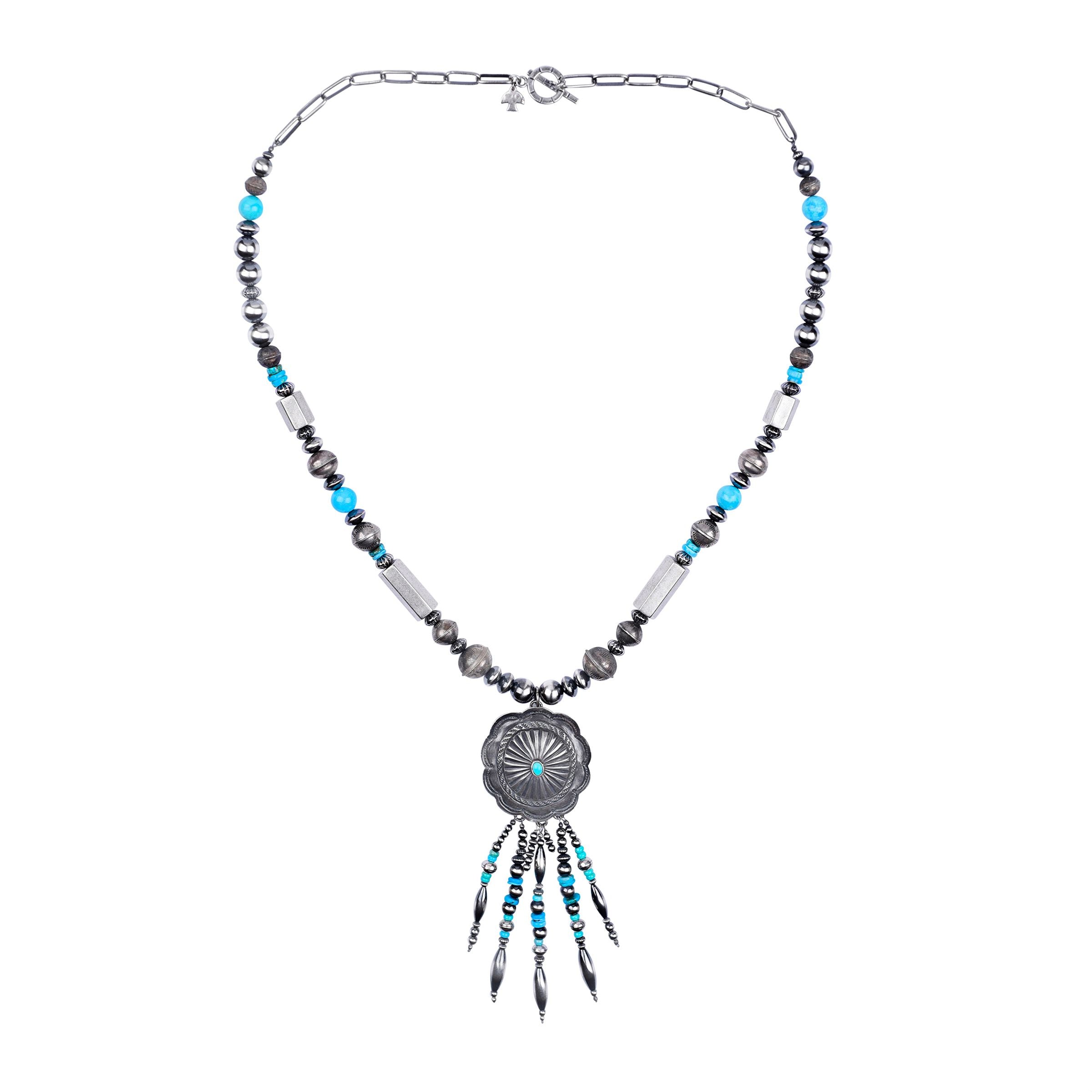 A sterling silver and turquoise necklace with vintage beads and feather-like dangles.