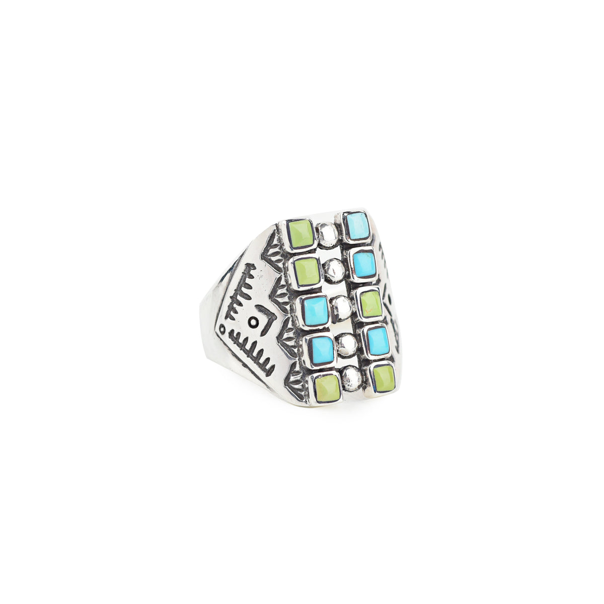 A sterling silver shield ring with a geometric pattern, blue and green turquoise stones, and detailed southwestern stamping.