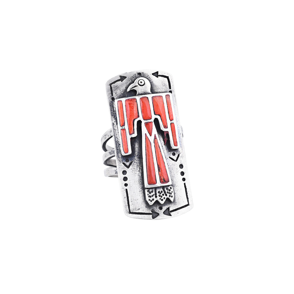 A sterling silver shield ring with red coral stones inlayed into an intricate thunderbird design. Added stamping and the split shank design of the band make this ring exceptional. 